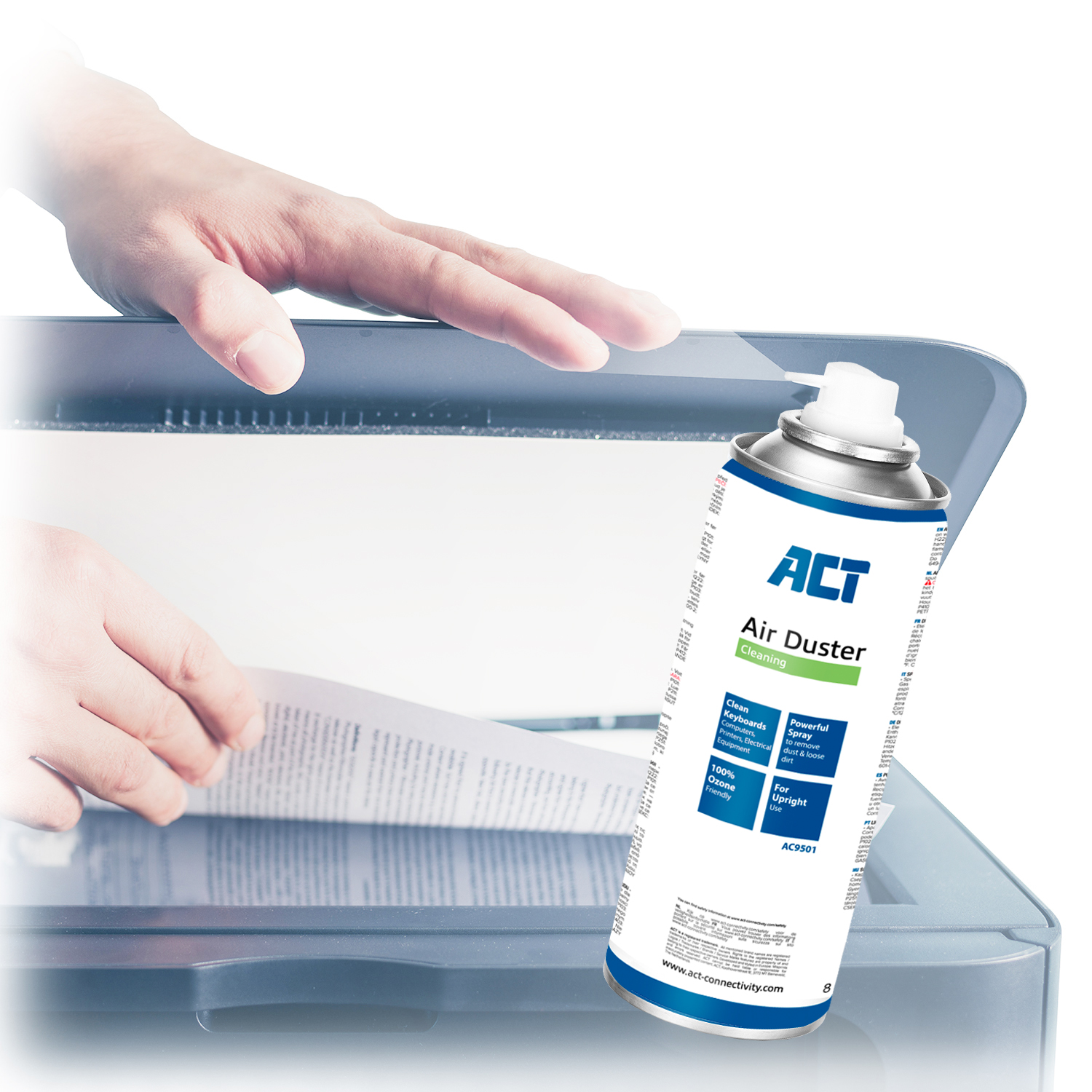 Hand using air duster on a scanner. The air duster is in focus with product details.