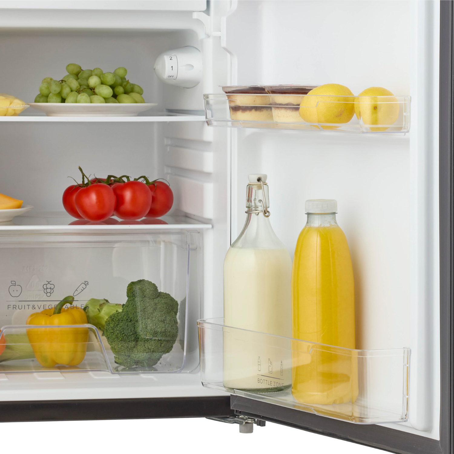Refrigerator open with food inside. Grapes, tomatoes, broccoli, lemons, bottles.