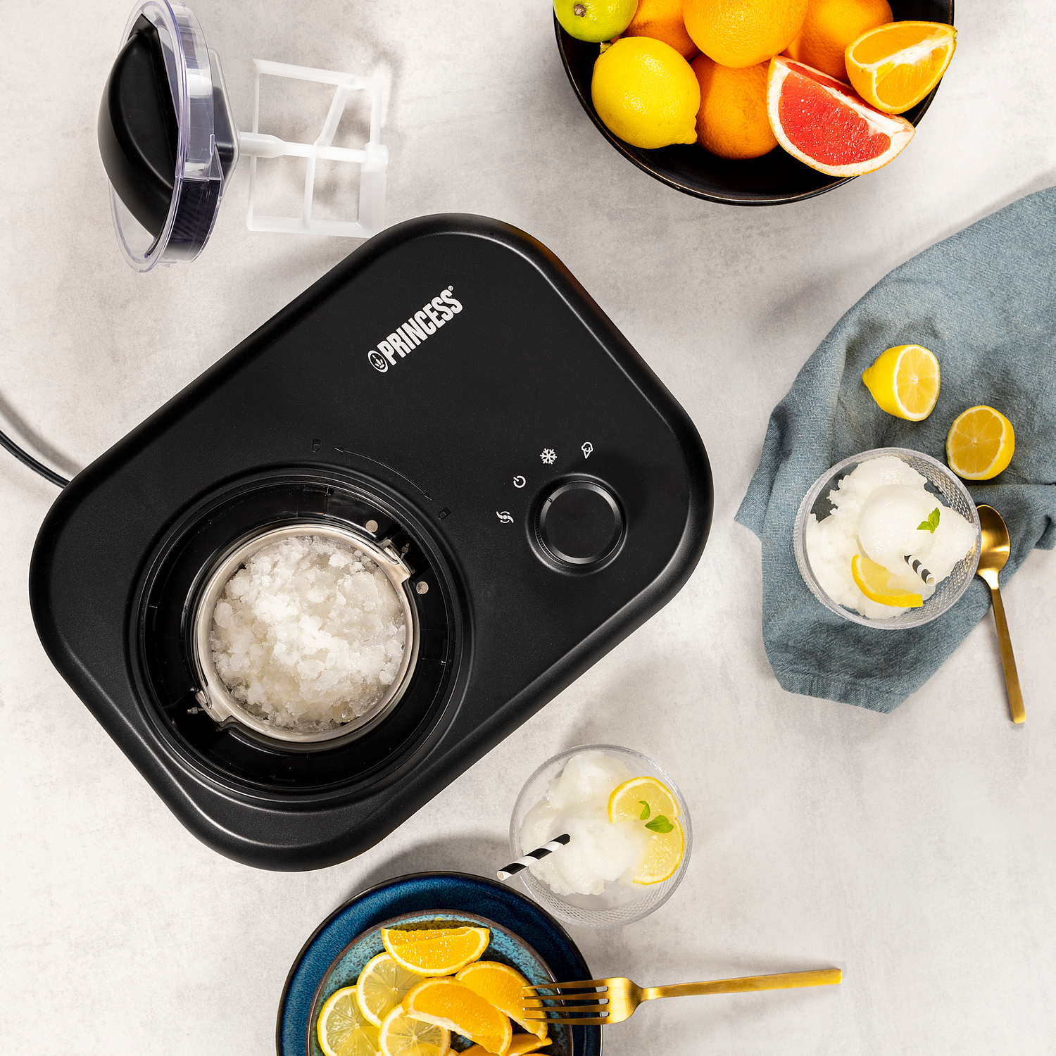Una gelatiera nera con ingredienti come limoni, arance e un cucchiaio d'oro.