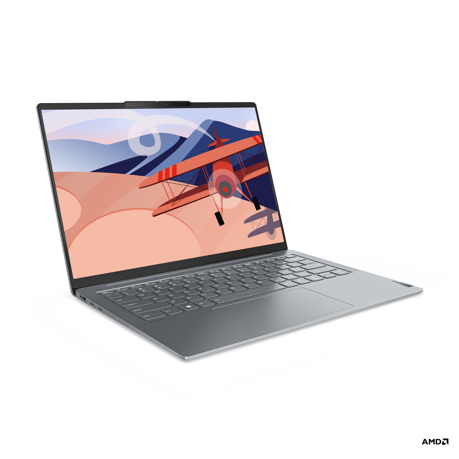 Ordinateur portable avec une scène de paysage à l'écran, un avion rétro vole au-dessus des montagnes. Clavier gris visible.
