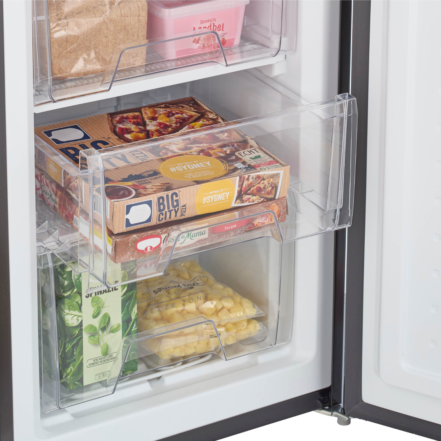 Freezer interior with pizza boxes, spinach, and corn in clear containers.