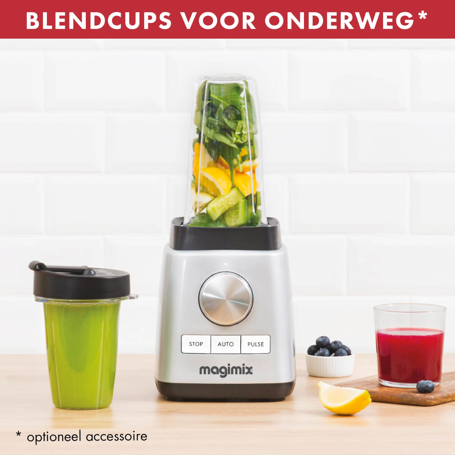 Blender with blended ingredients and a green cup, on a wooden surface.