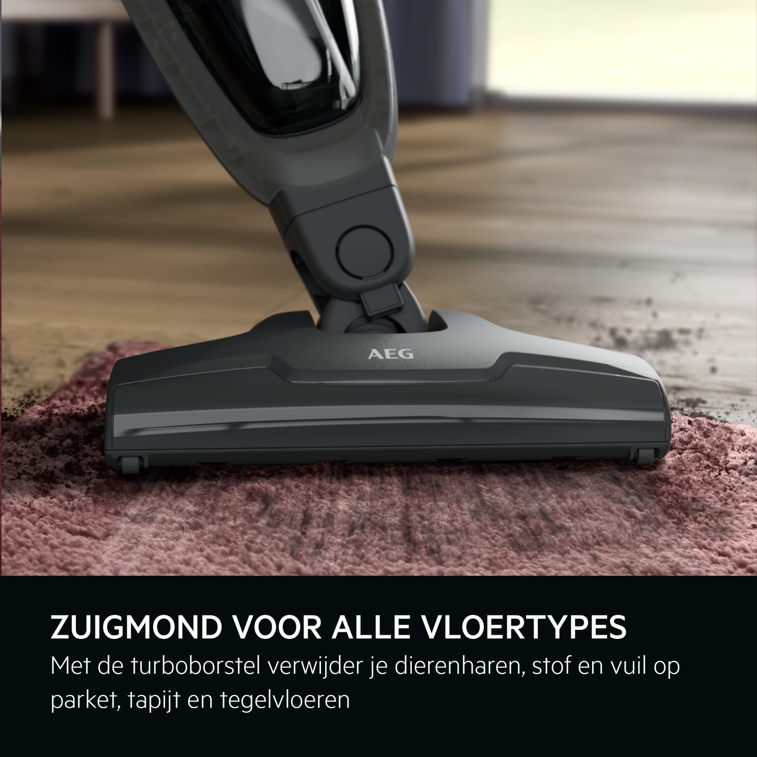 A black vacuum cleaner head on a pink rug. The text in English at the bottom.