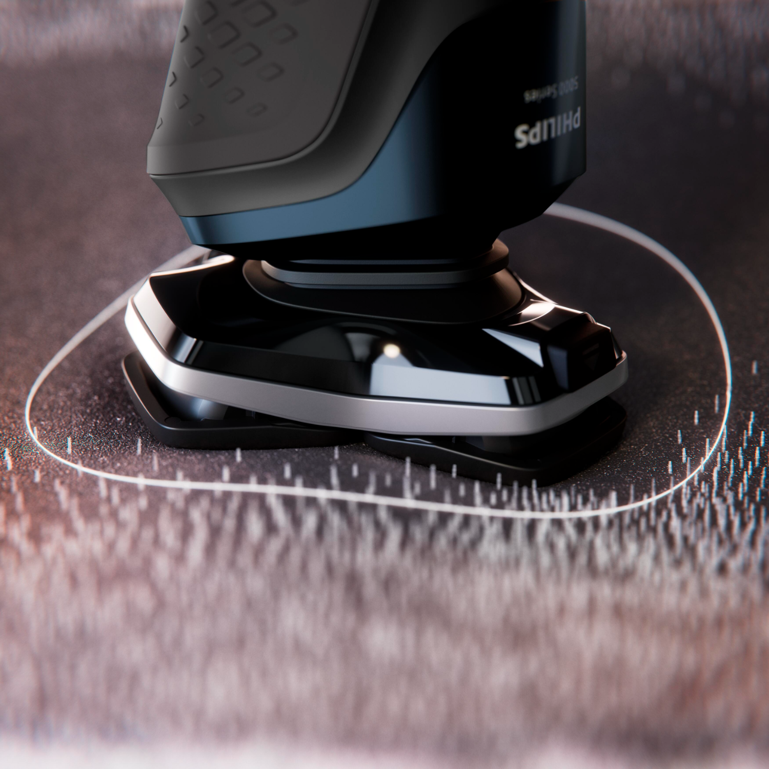 Zbliżenie golarki elektrycznej Philips. Ostrza są czarne, korpus niebiesko-czarny.