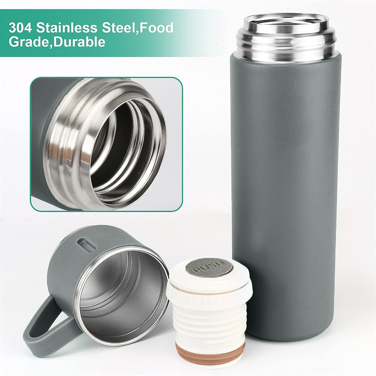 Eine graue Thermosflasche mit silbernem Deckel. Eine Tasse und ein Deckel liegen daneben.