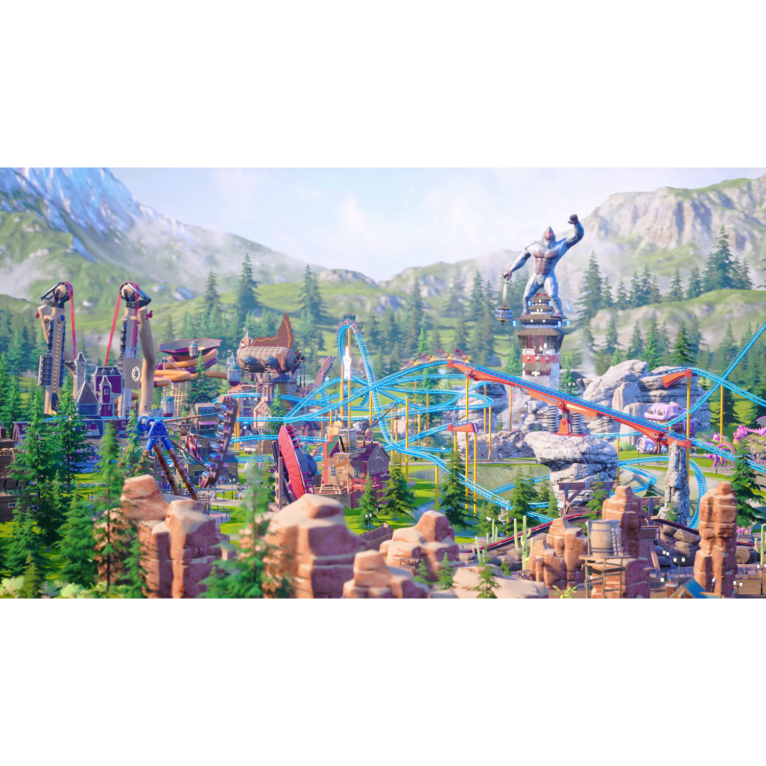 Kolorowy park rozrywki z kolejkami górskimi, budynkami i górami w tle.