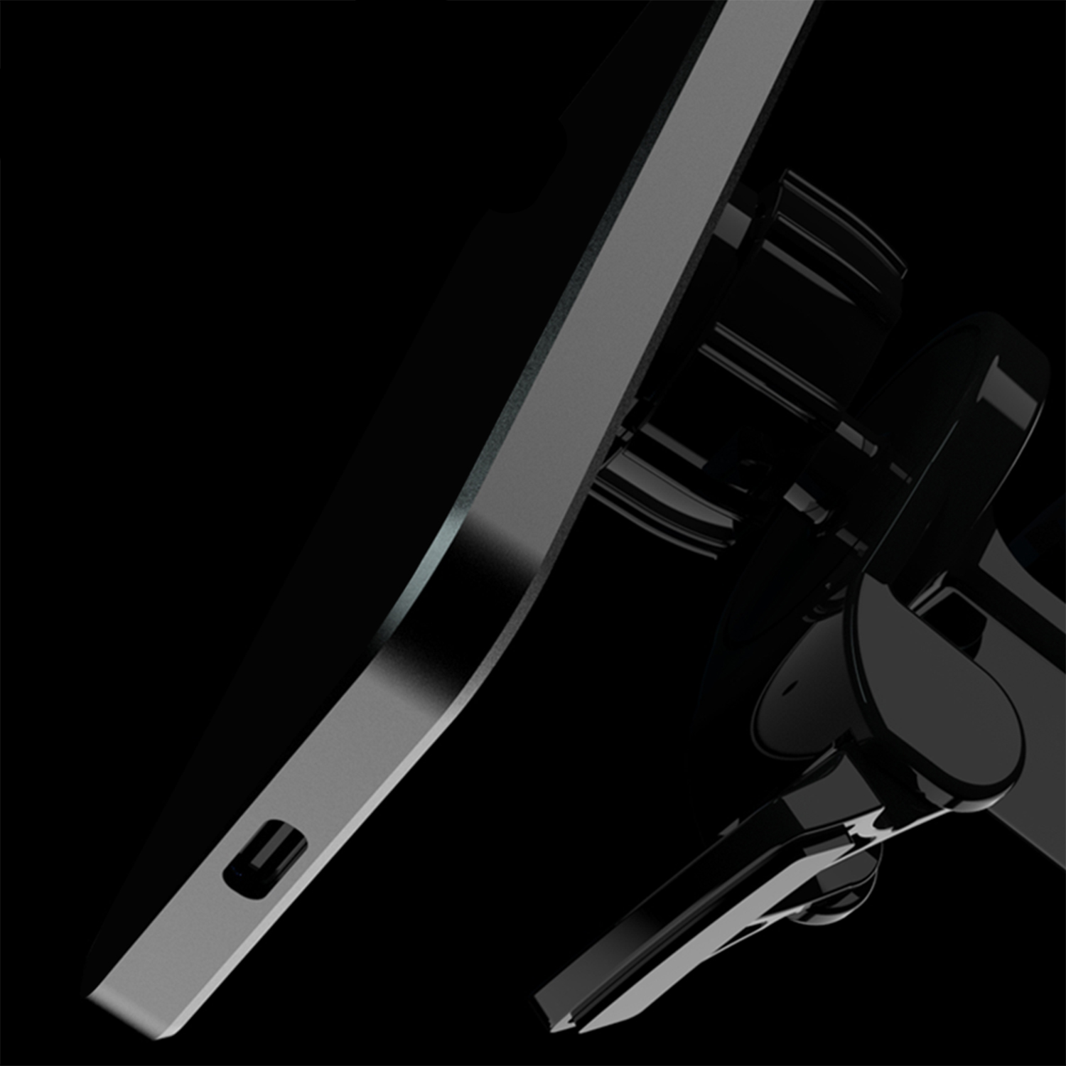 Primo piano di un dispositivo nero con bordo metallico grigio, su sfondo nero.