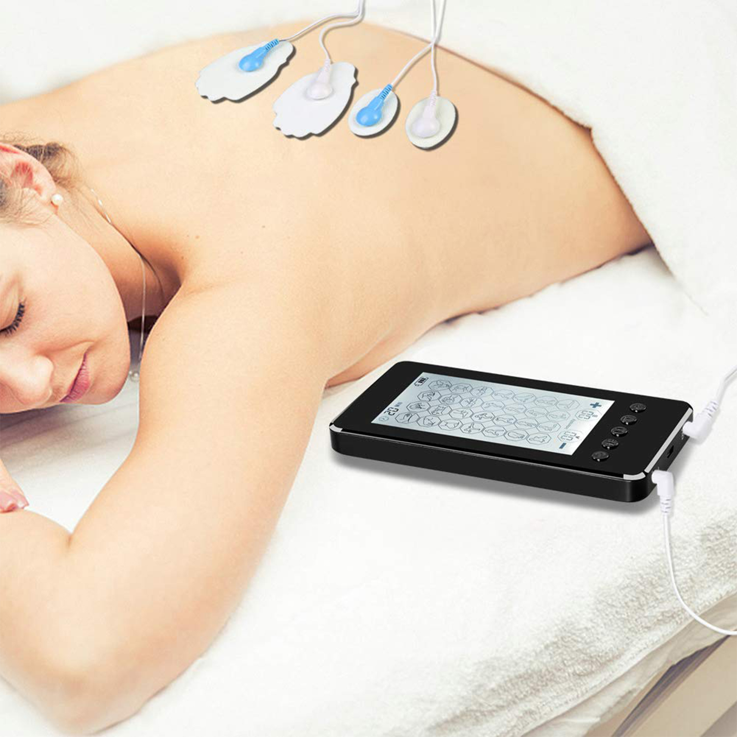 Mujer acostada boca abajo con una máquina TENS conectada a su espalda. Se ven cables y almohadillas de electrodos.