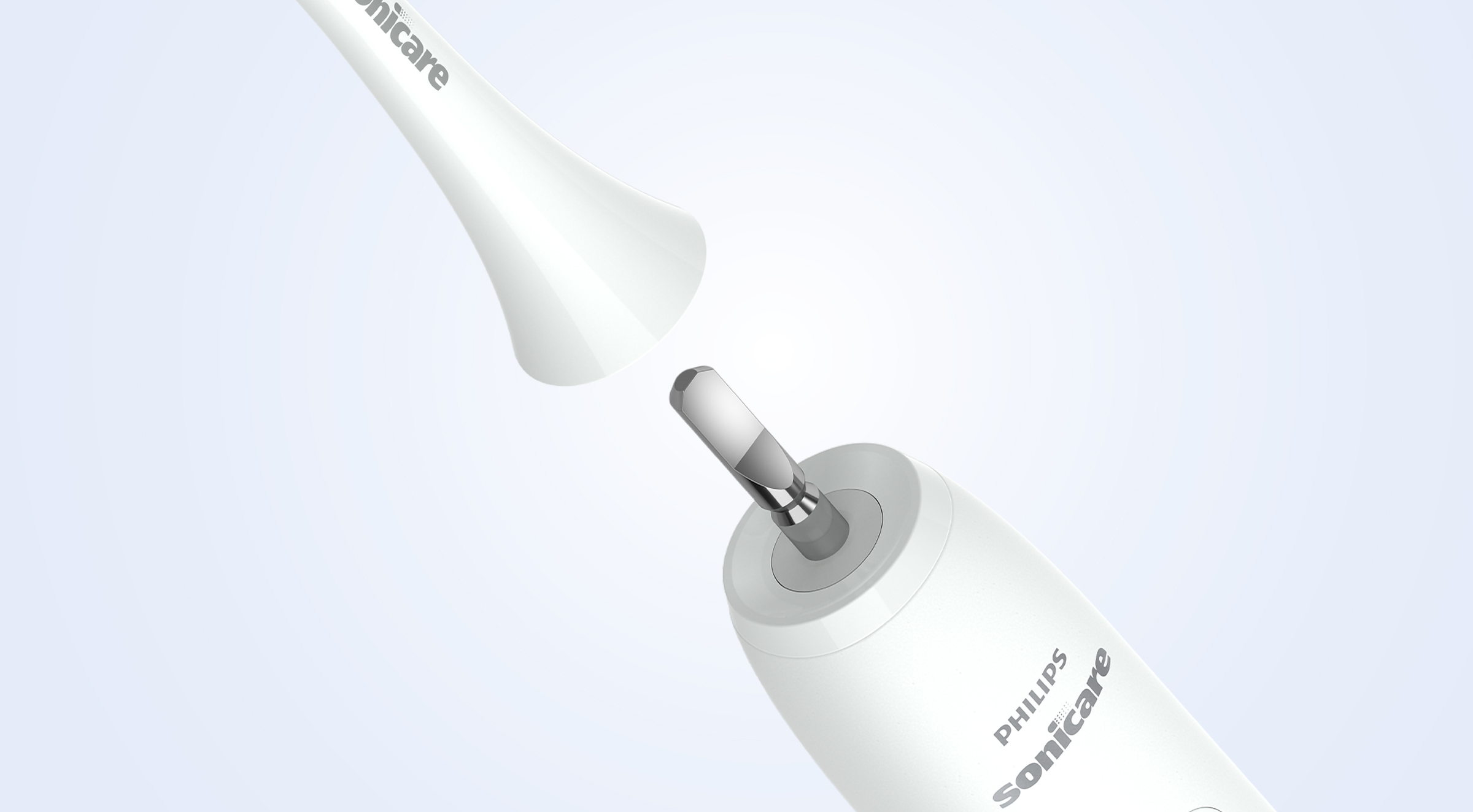 Zbliżenie białej główki szczoteczki Sonicare, która jest mocowana do uchwytu.
