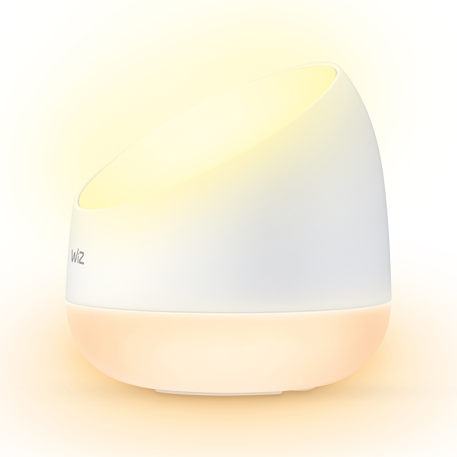 A white lamp with a rounded base and a tilted top, emitting a warm glow.