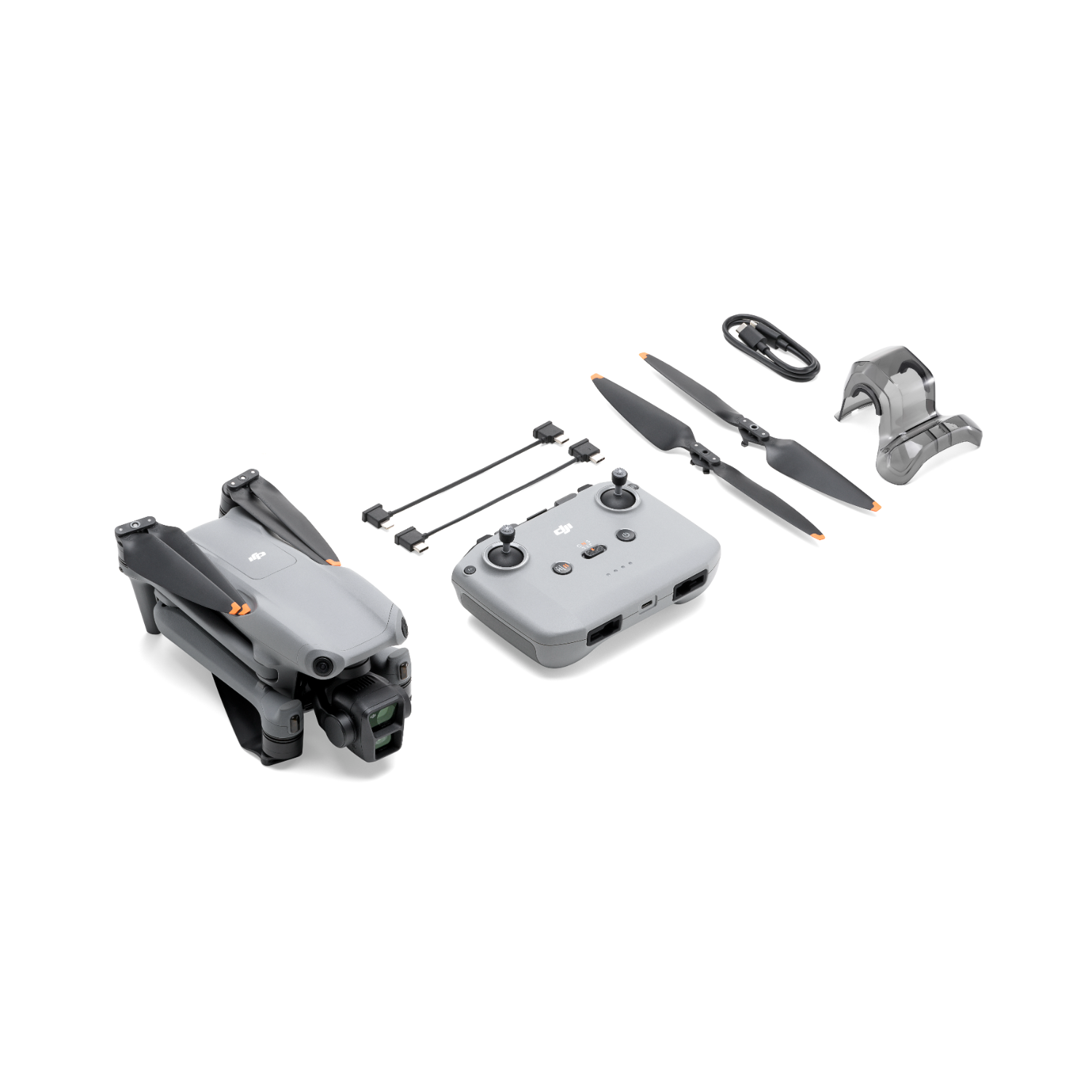 Dron i jego akcesoria ułożone na białej powierzchni. Widoczne śmigła, pilot i ładowarka.