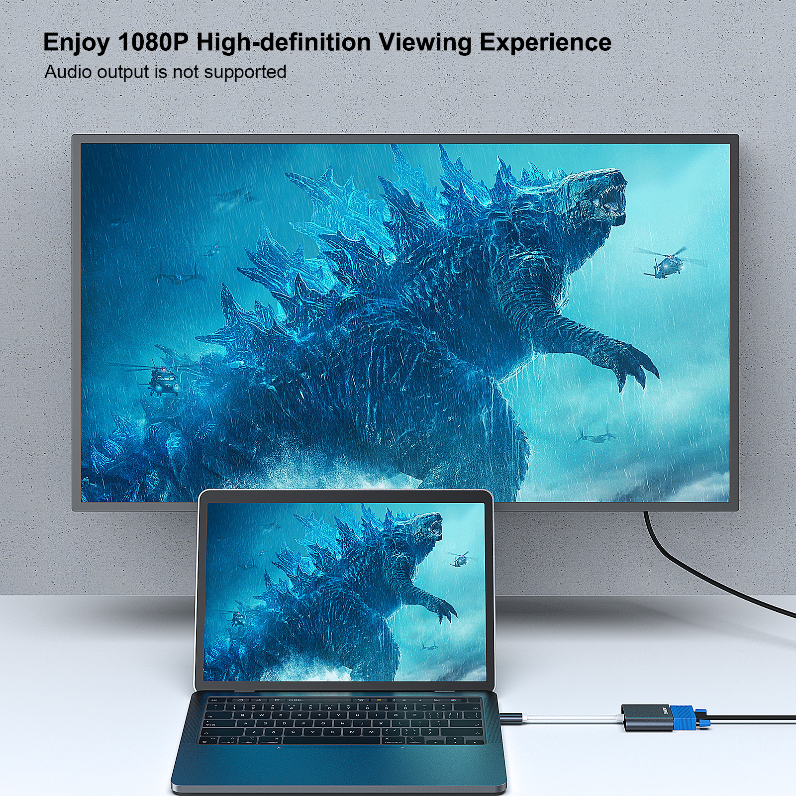 Laptop-Bildschirm zeigt Godzilla-Filmszene, verbunden mit einem größeren Fernseher.
