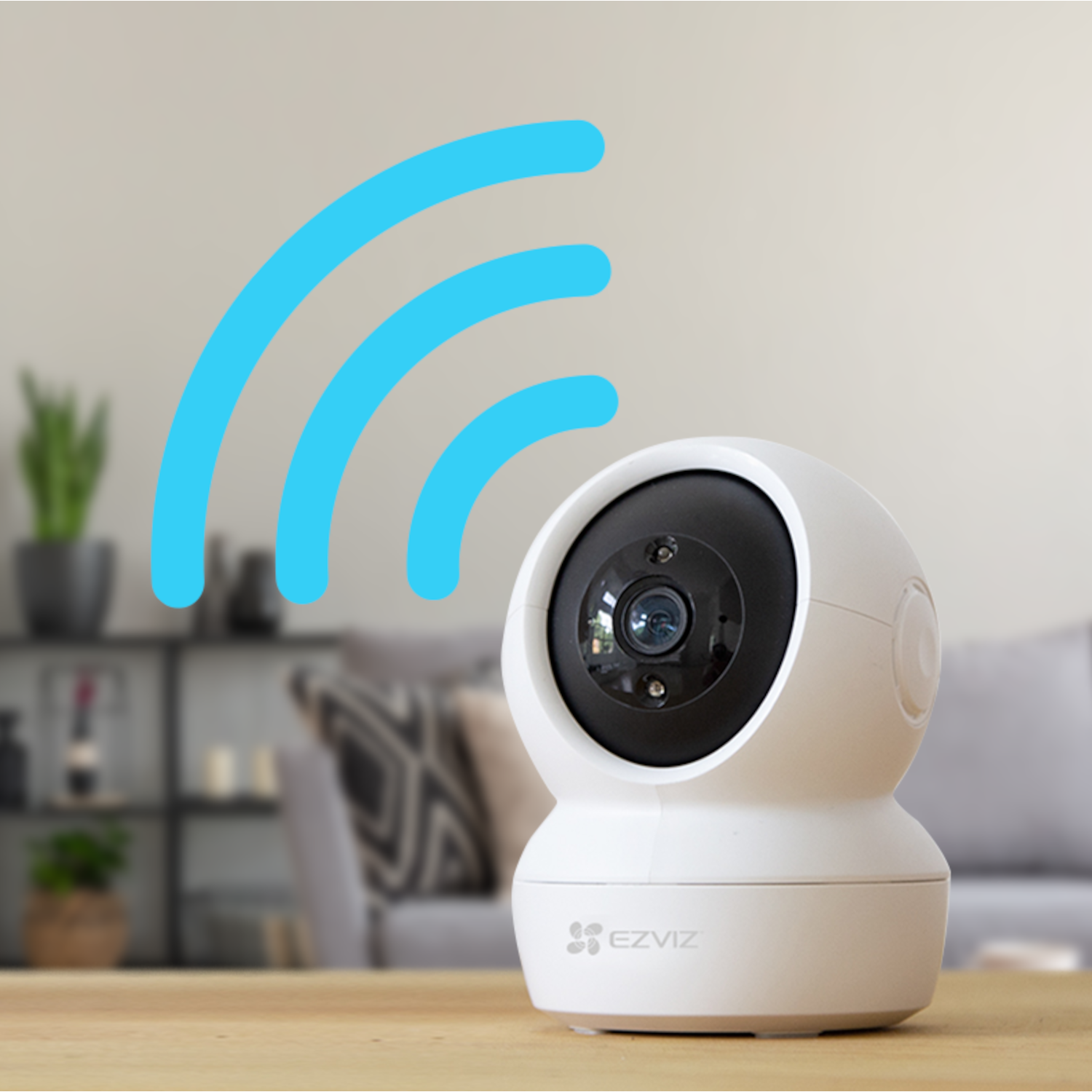 Biała kamera bezpieczeństwa na stole, z niebieskimi sygnałami Wi-Fi nad nią.