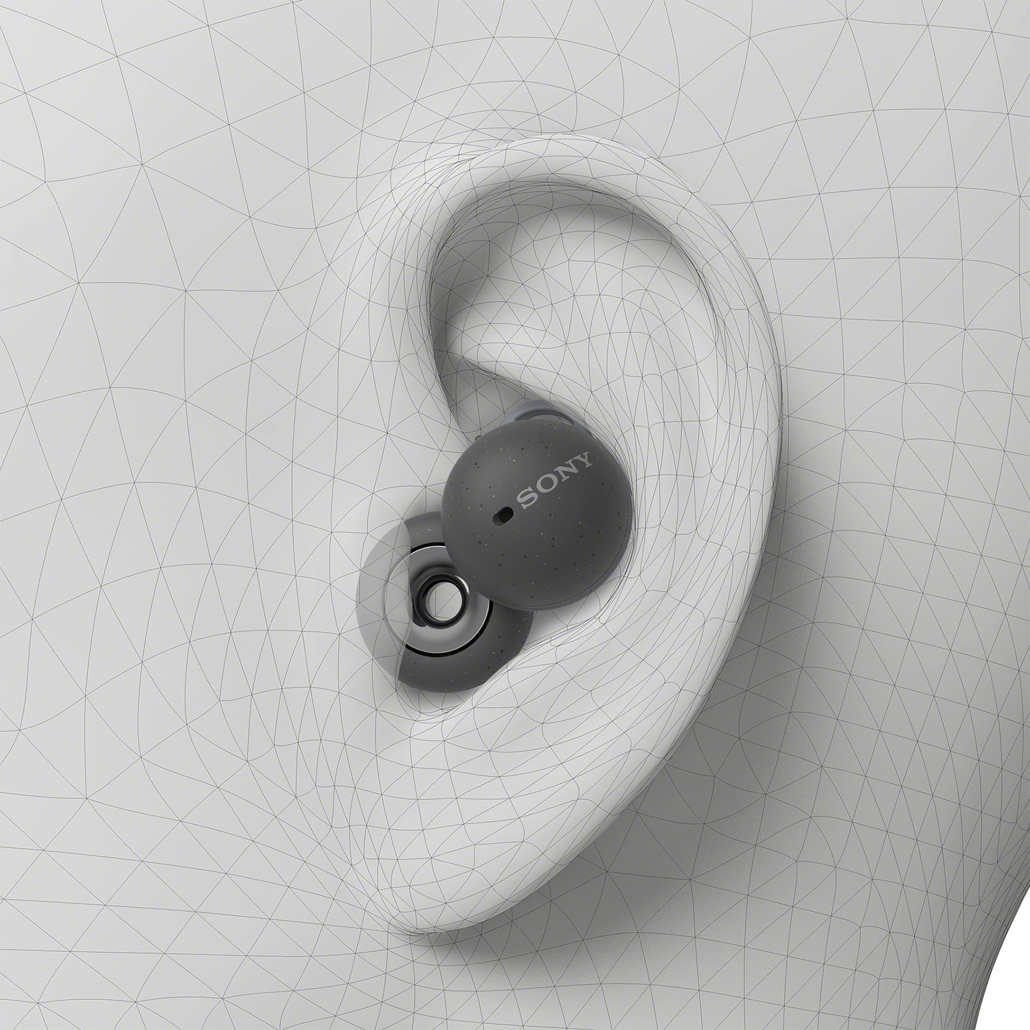 Los auriculares se muestran en un modelo de oreja. El auricular izquierdo está en su lugar, el derecho está listo para insertar.
