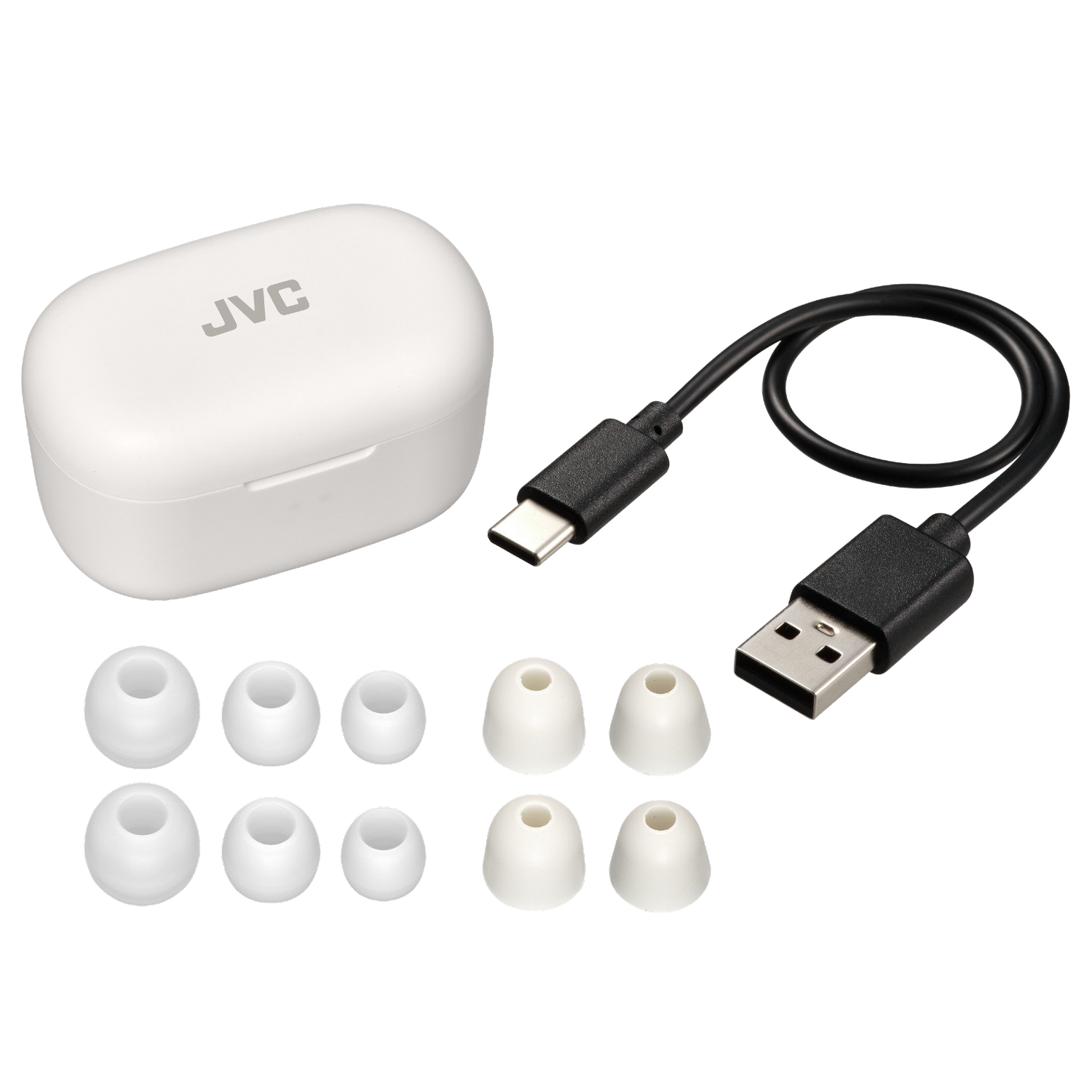 Białe słuchawki JVC, etui ładujące, kabel USB i wkładki douszne.