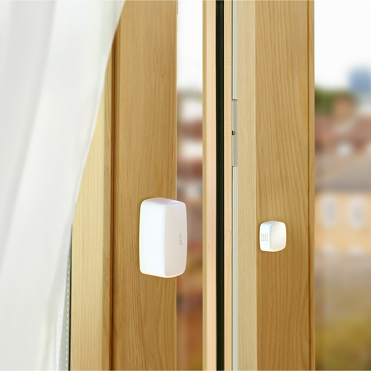 Rama drzwi z dwoma białymi czujnikami zamontowanymi na drzwiach i ramie.