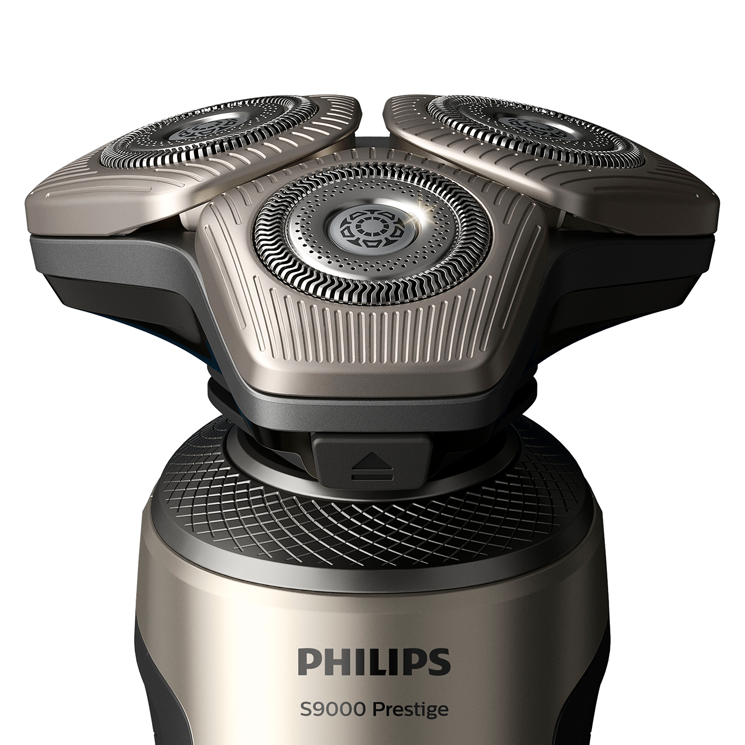 Primer plano de una afeitadora eléctrica Philips. Tiene múltiples cabezales plateados y base dorada.
