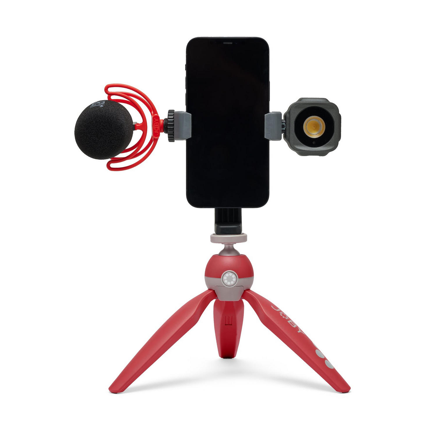 Smartphone with light and microphone on a red tripod.