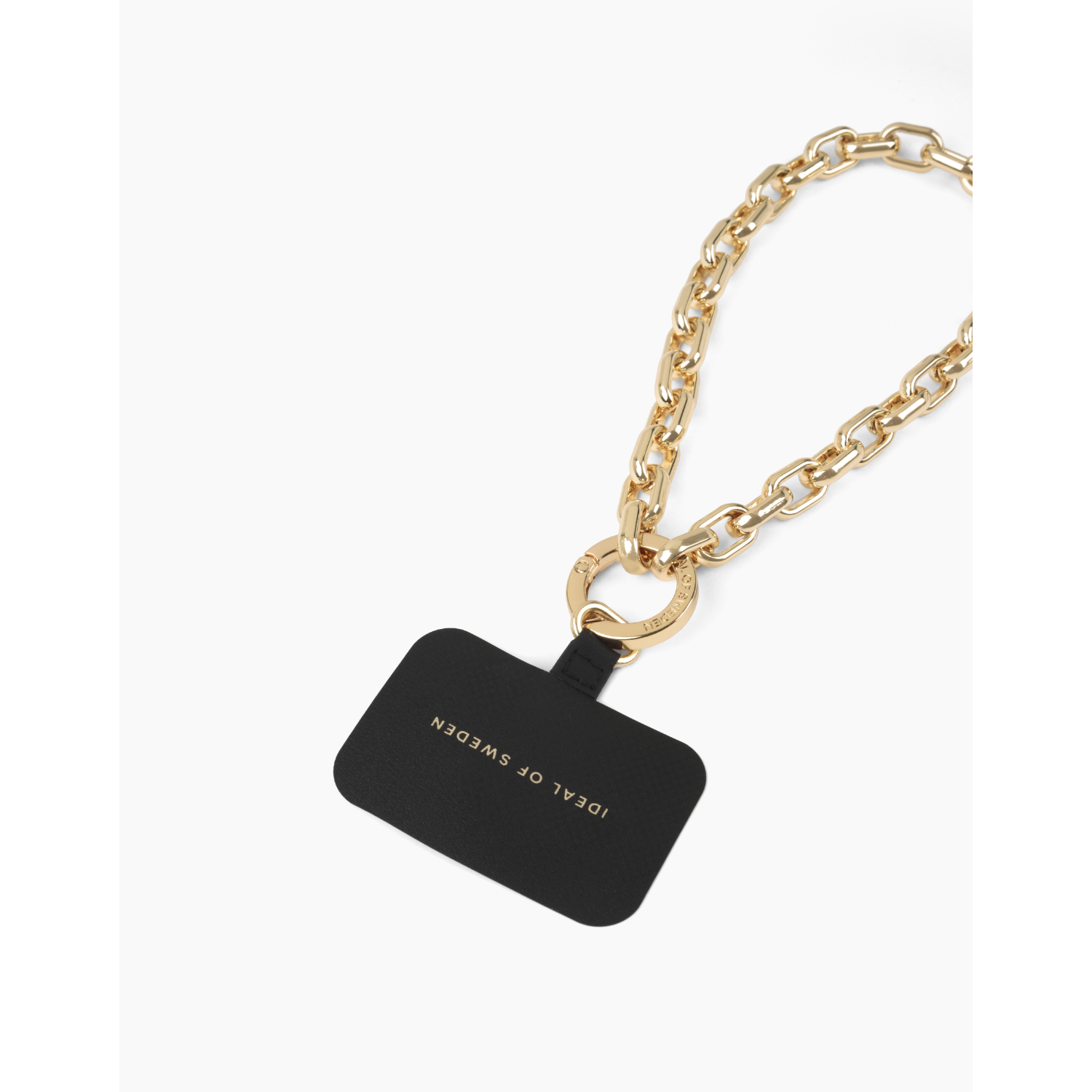 Eine schwarze Handyhülle mit goldenem Kettengurt und einem kleinen schwarzen Anhänger mit der Aufschrift "IDEAL OF SWEDEN".