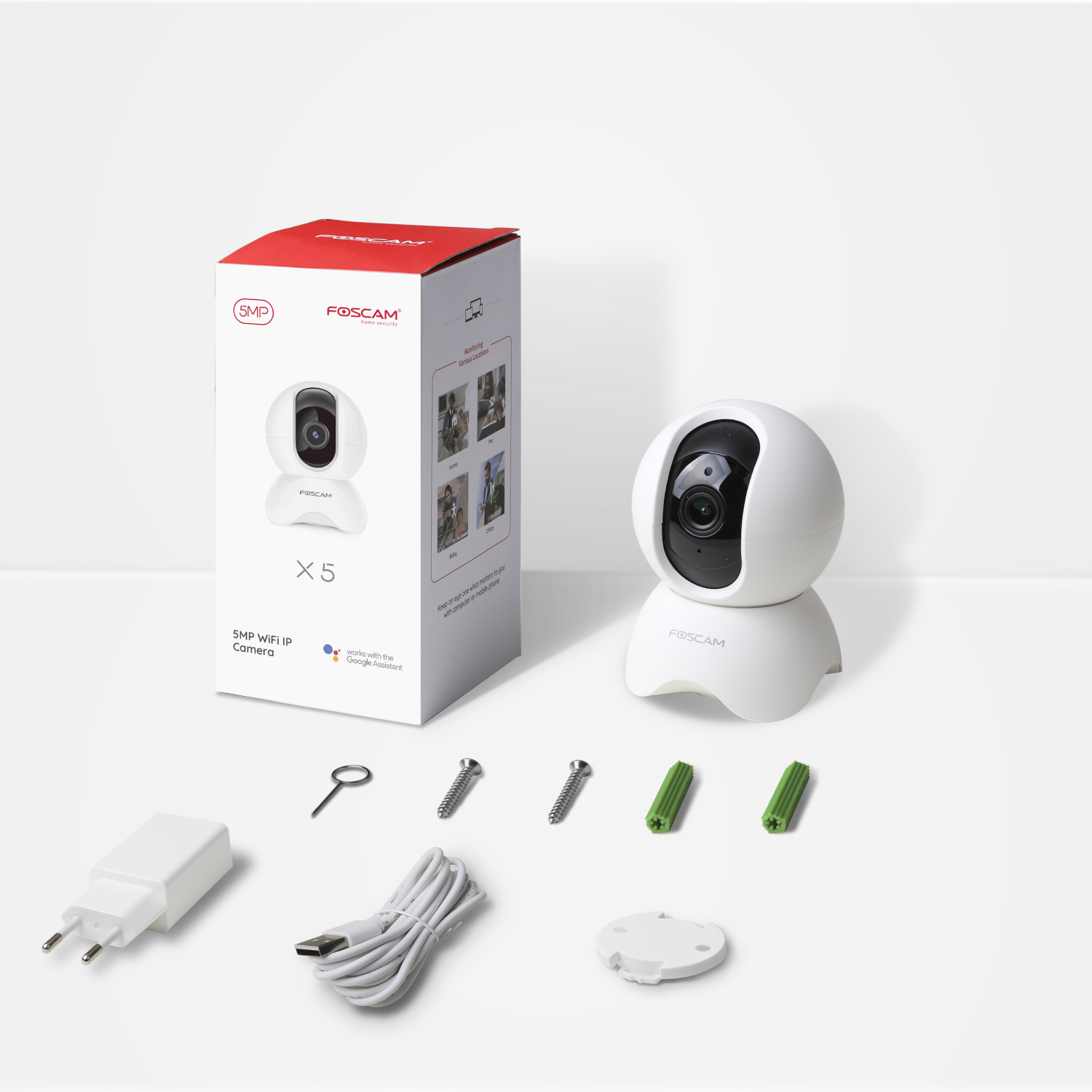 White security camera and box with accessories. Charger, screws, and other items. White background.