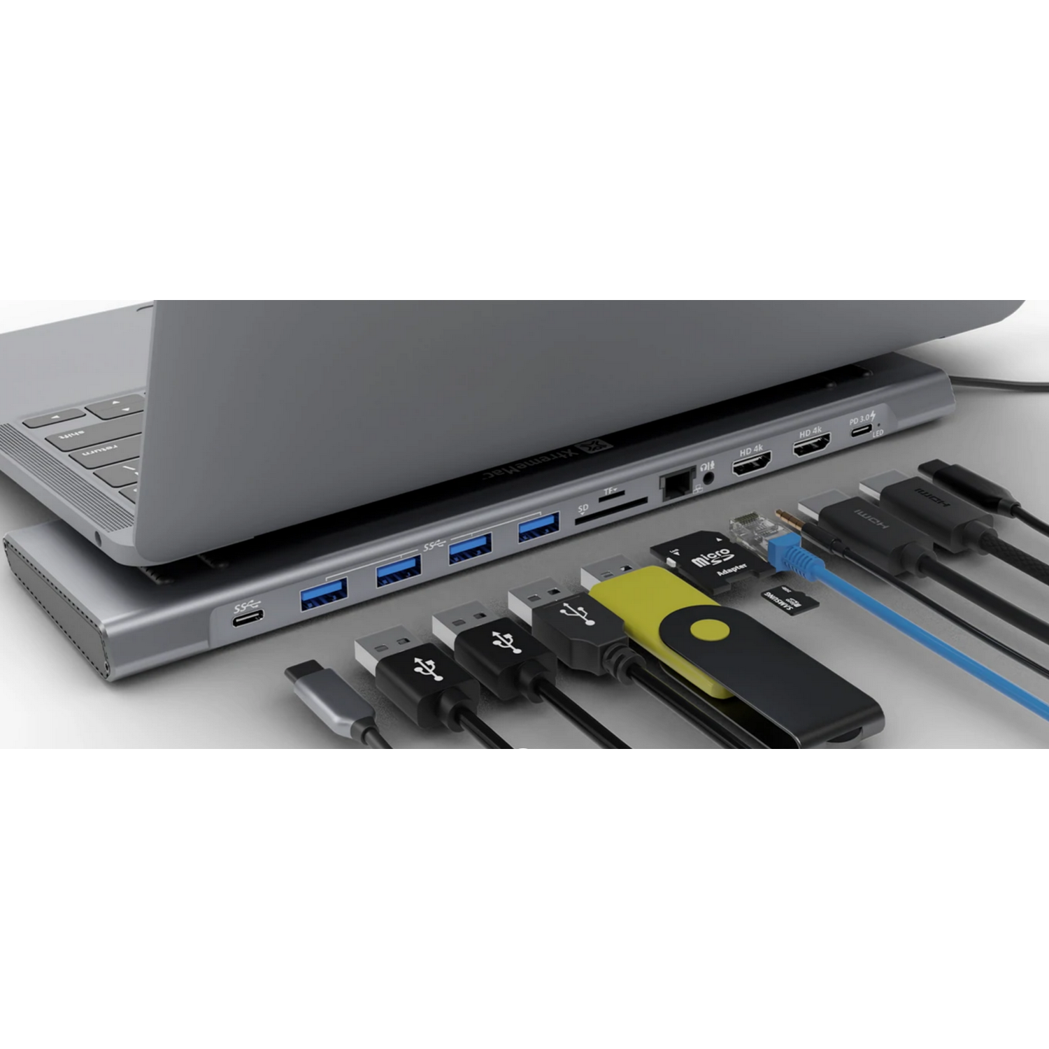 A laptop connected to a hub with multiple ports, and various cables.