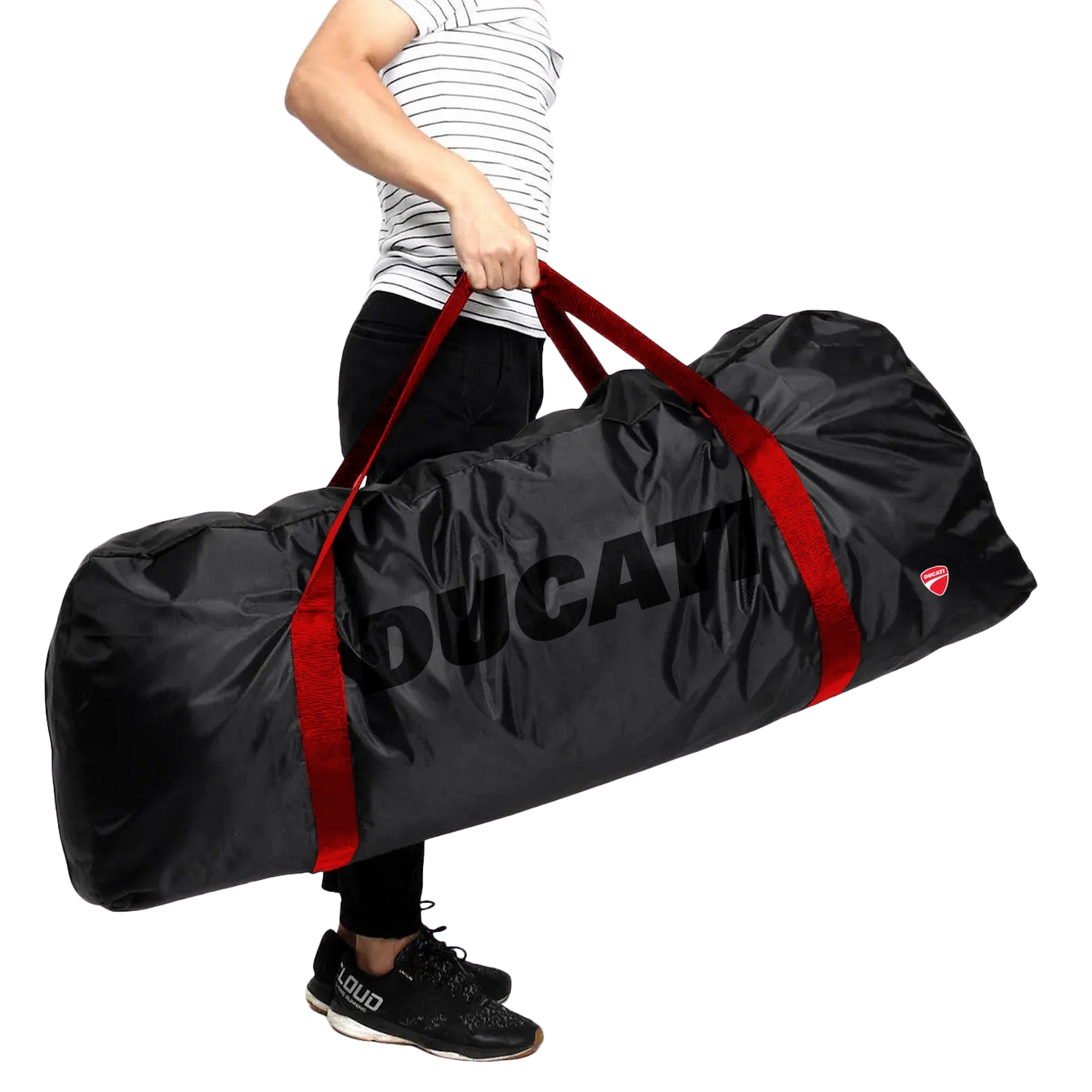 A person holding a black duffel bag with red straps and the word DUCATI on it.