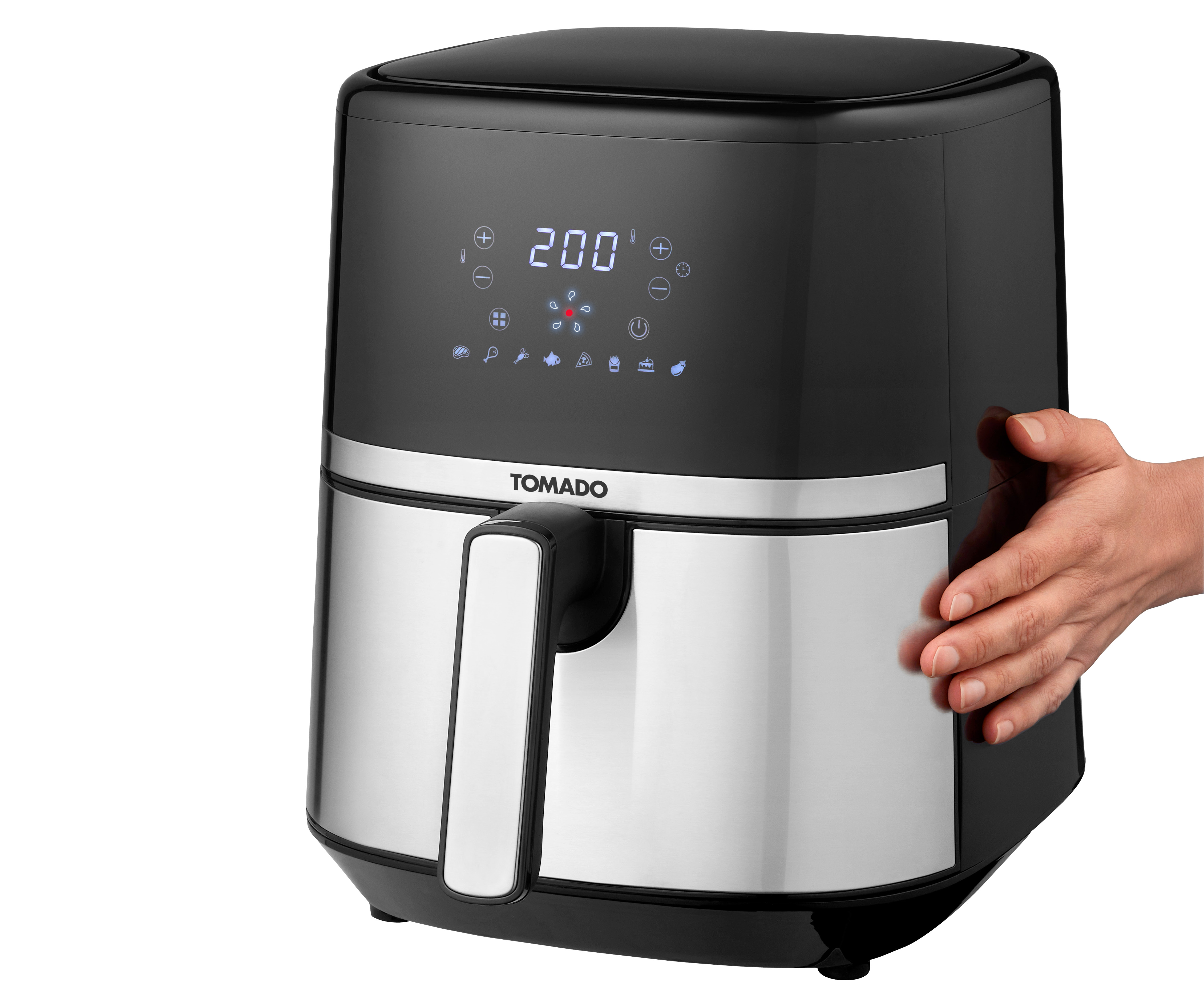 Zwarte en zilveren Tomado airfryer. Een hand raakt de zijkant van het apparaat aan.