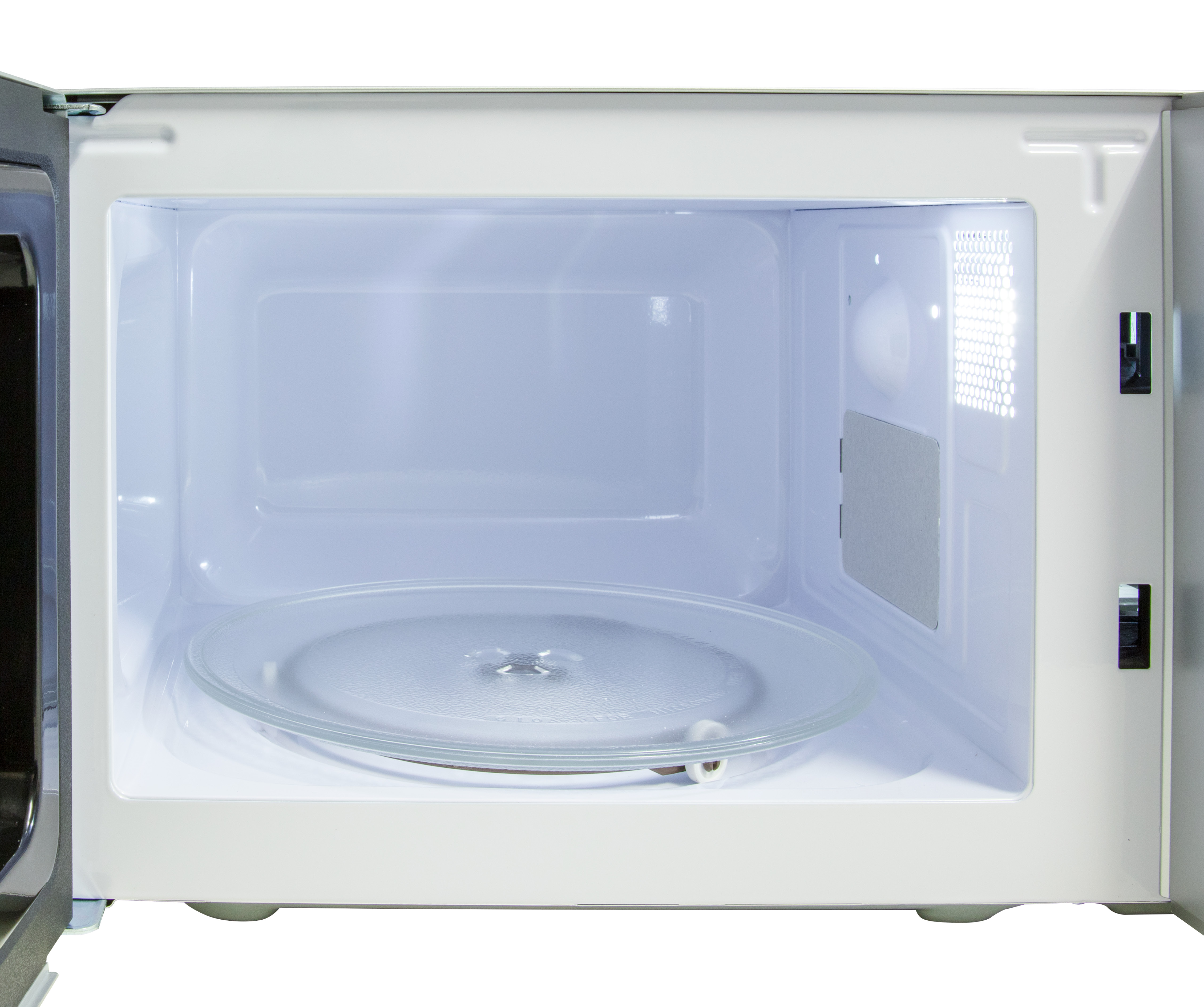 Interior of a white microwave with a glass plate. The door is open.