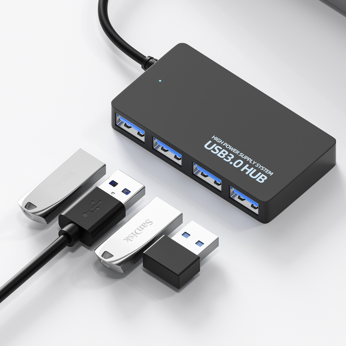 Schwarzer USB 3.0-Hub mit vier USB-Anschlüssen. Zwei silberne USB-Laufwerke und ein schwarzes sind angeschlossen.