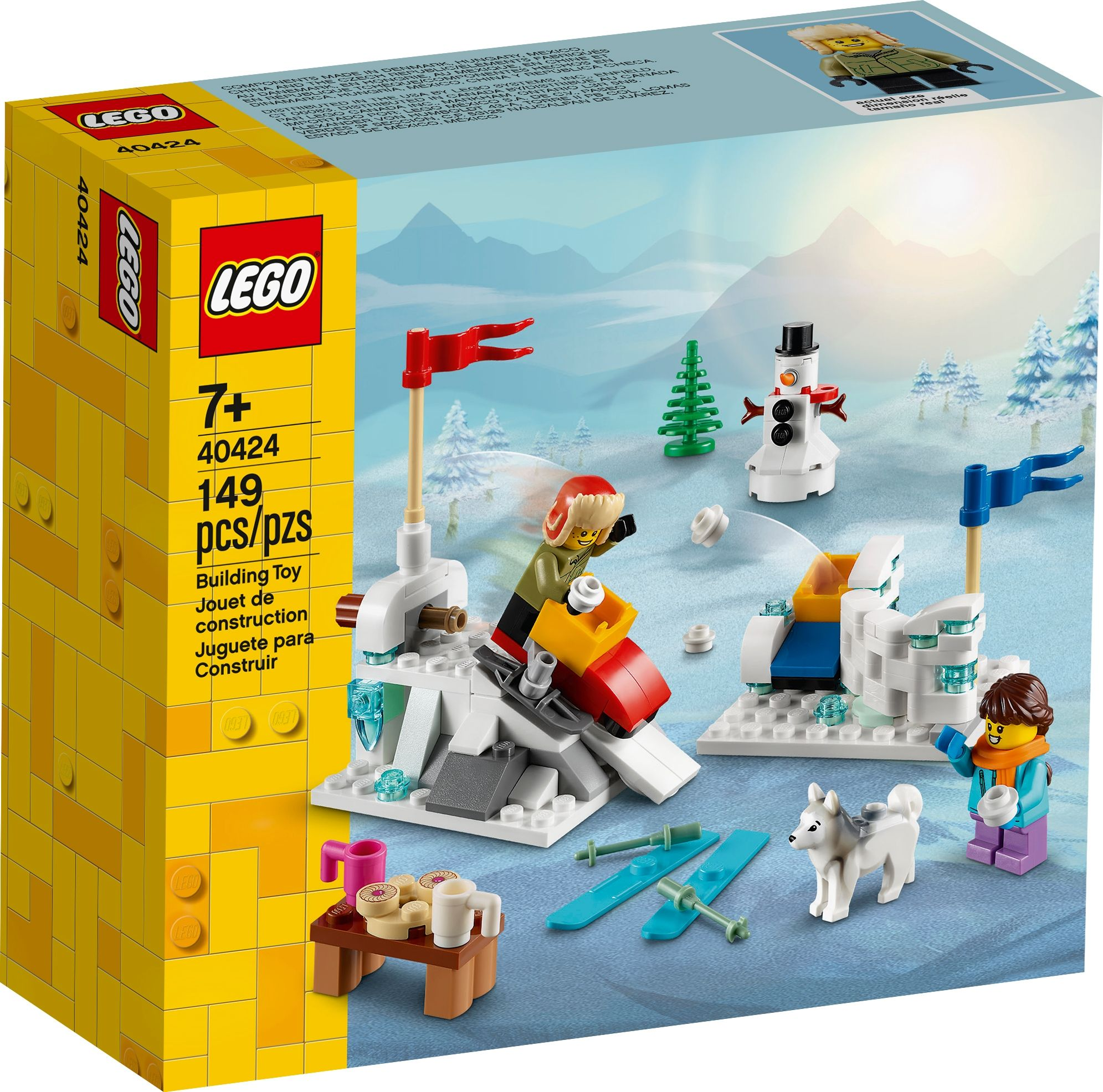 LEGO seti. Kardan adam, kayakçı, köpek ve renkli öğelerle kar sahnesi içerir.