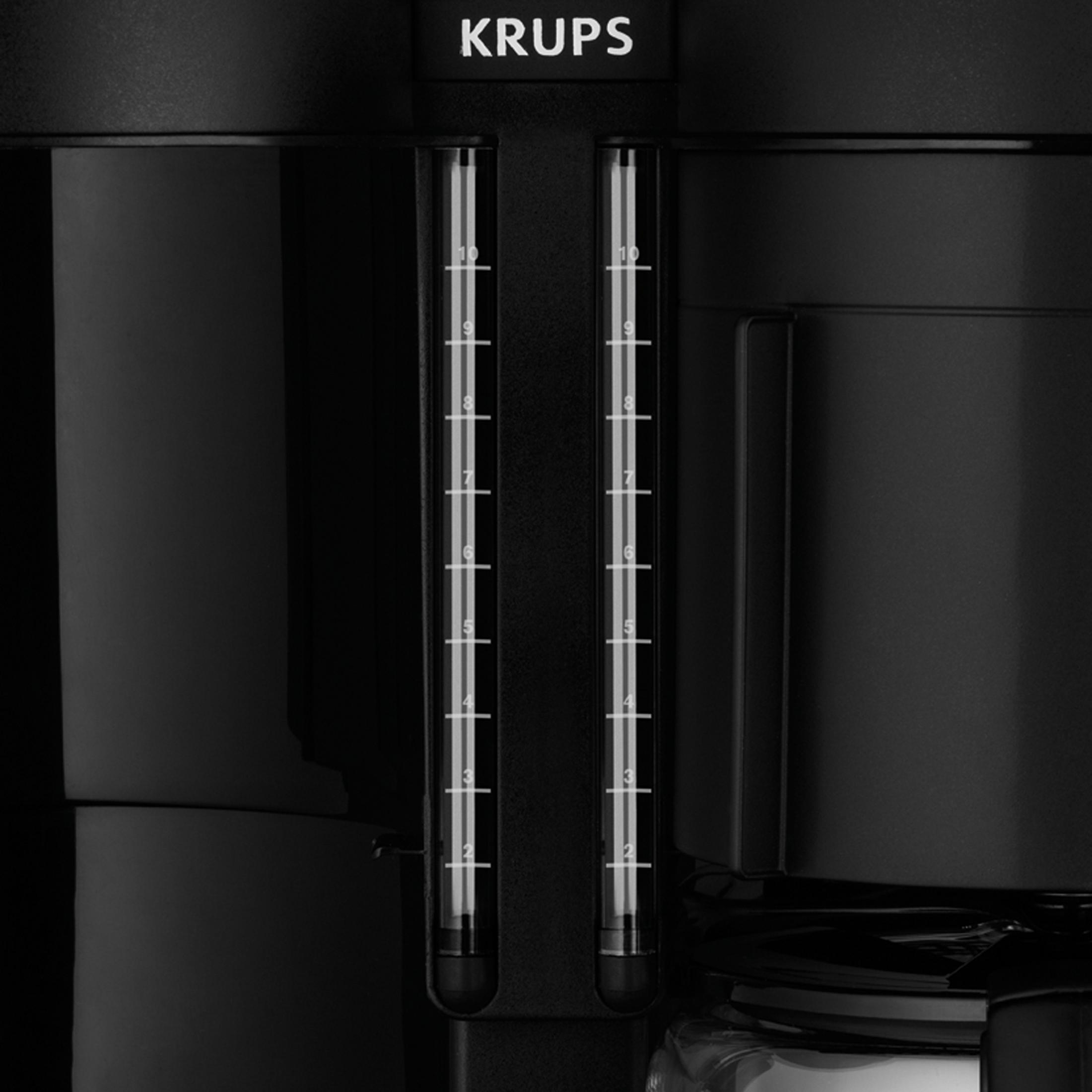 Czarny ekspres do kawy Krups ze wskaźnikami poziomu wody, zbliżenie.