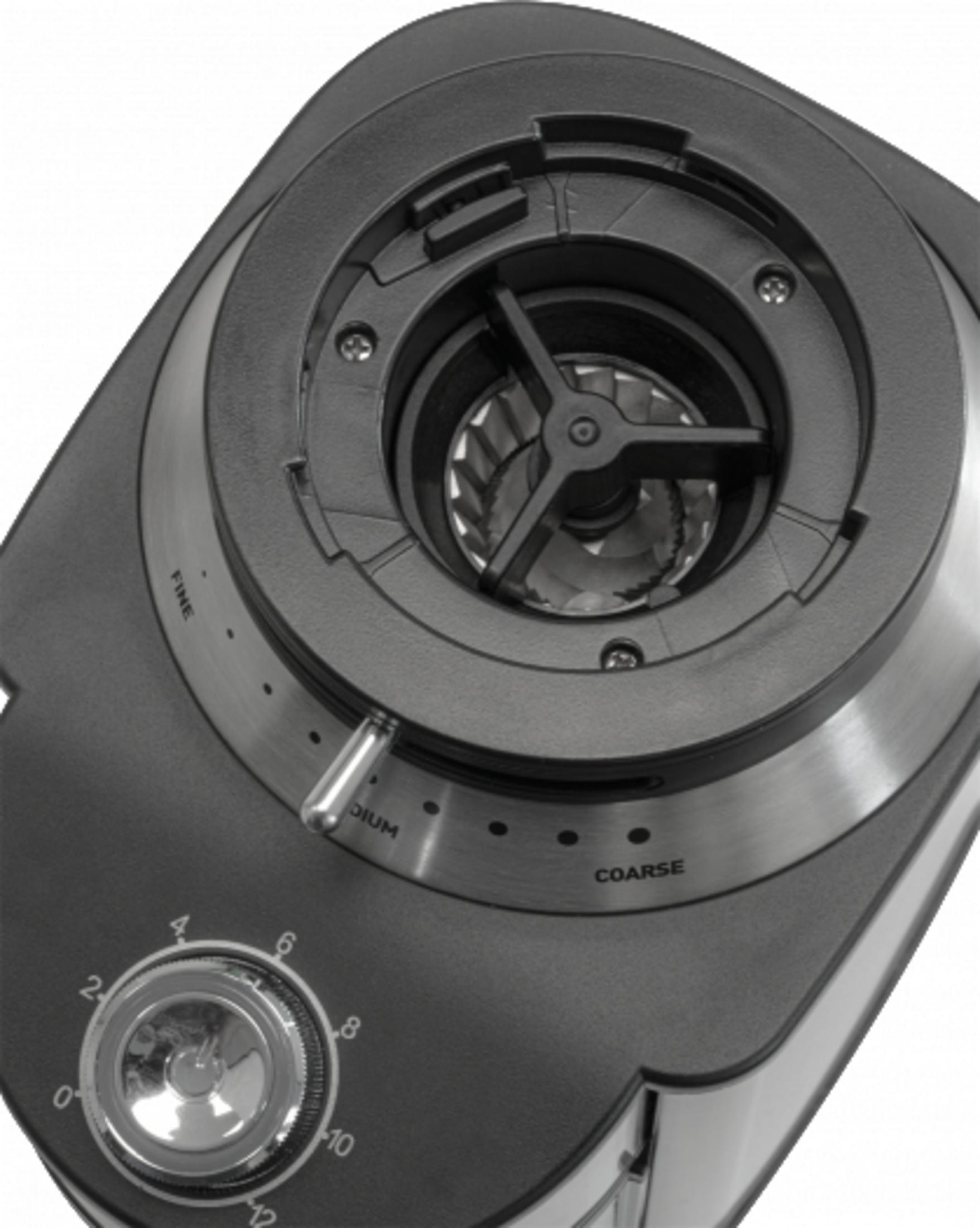 Zbliżenie na młynek do kawy. Ma tarczę z numerami i srebrną rączkę.