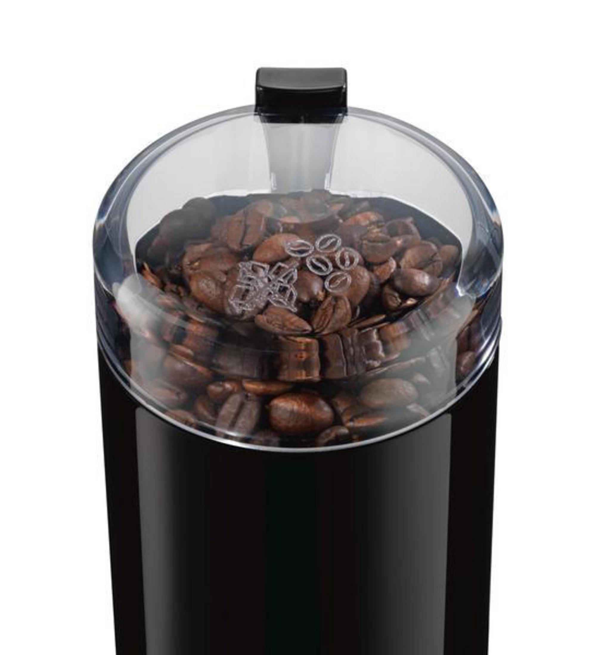 Black coffee grinder with transparent lid, filled with coffee beans. Black background.