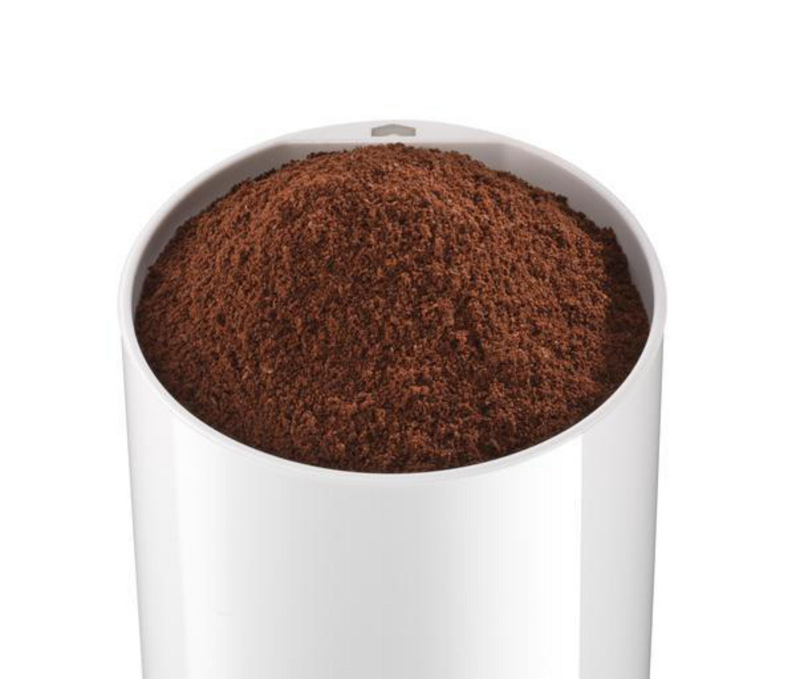 A white container filled with ground coffee on a white background. The container is cylindrical.