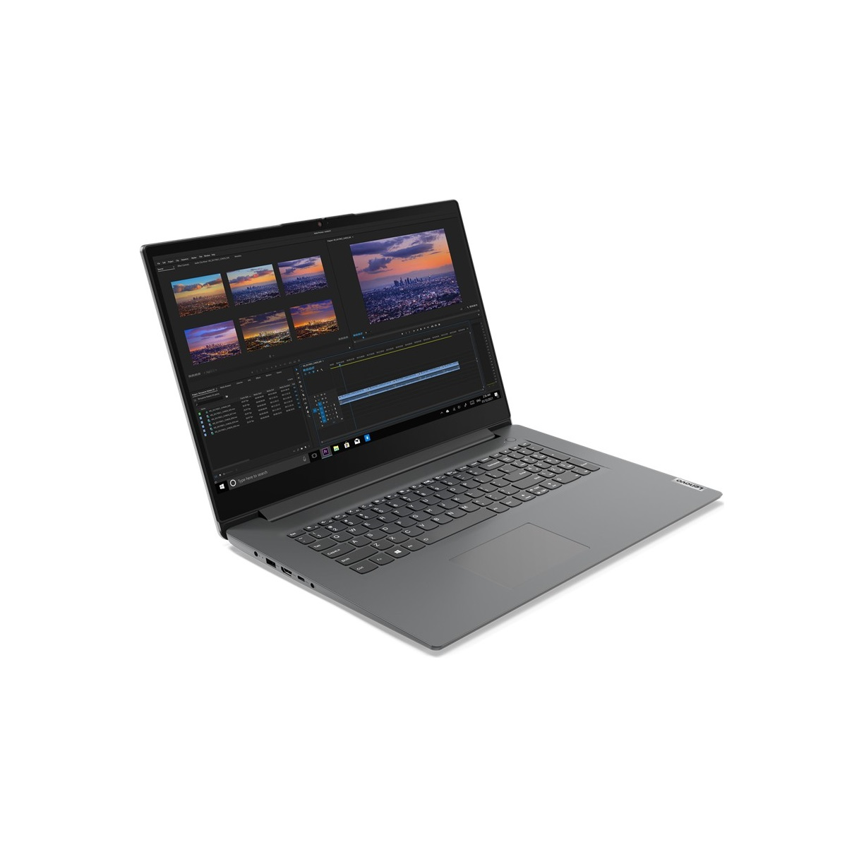 Grauer Laptop auf weißer Oberfläche, Bildschirm zeigt Videoschnittsoftware mit Skyline im Hintergrund.
