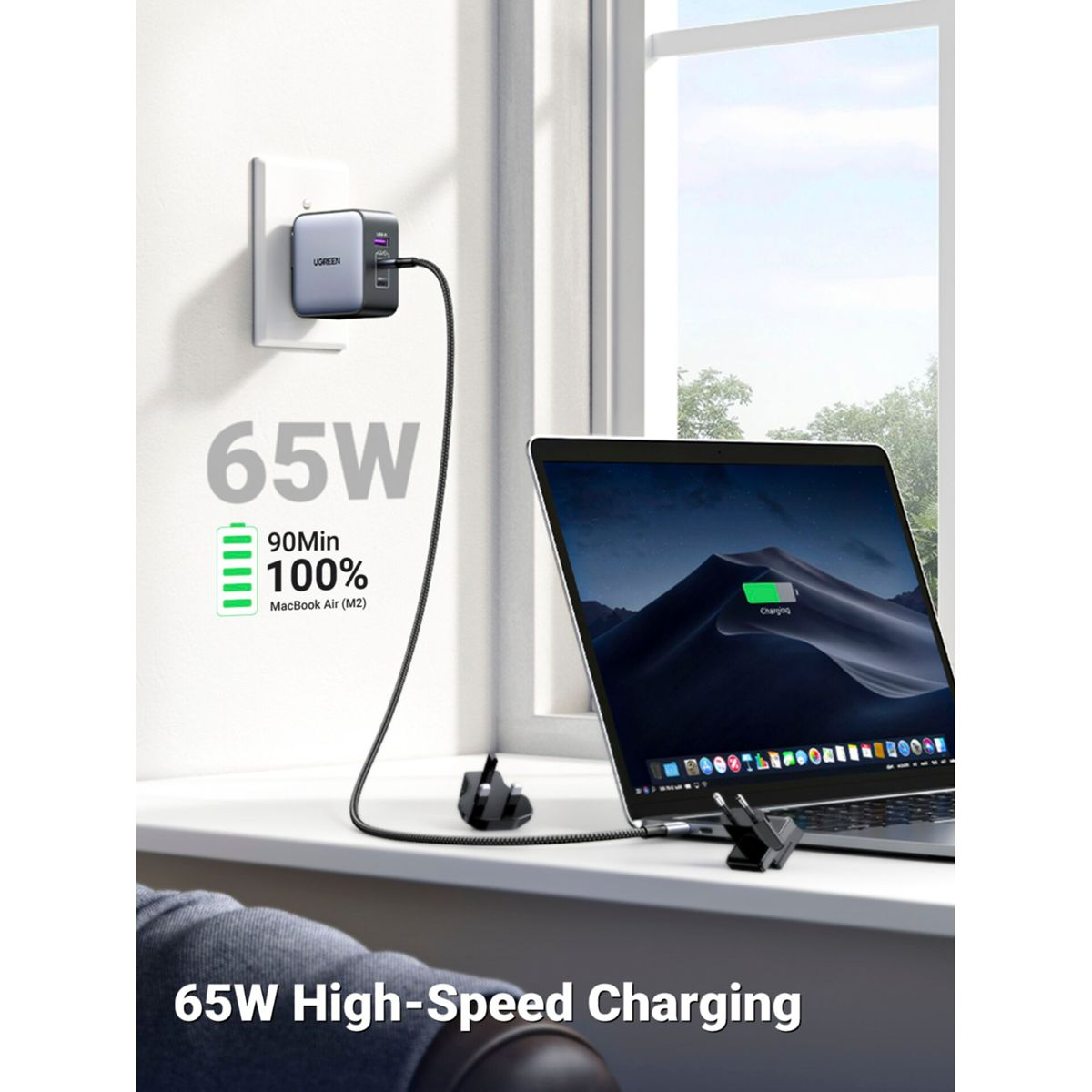 A charger with a cable connected to a laptop. Text says 65W and 90Min.