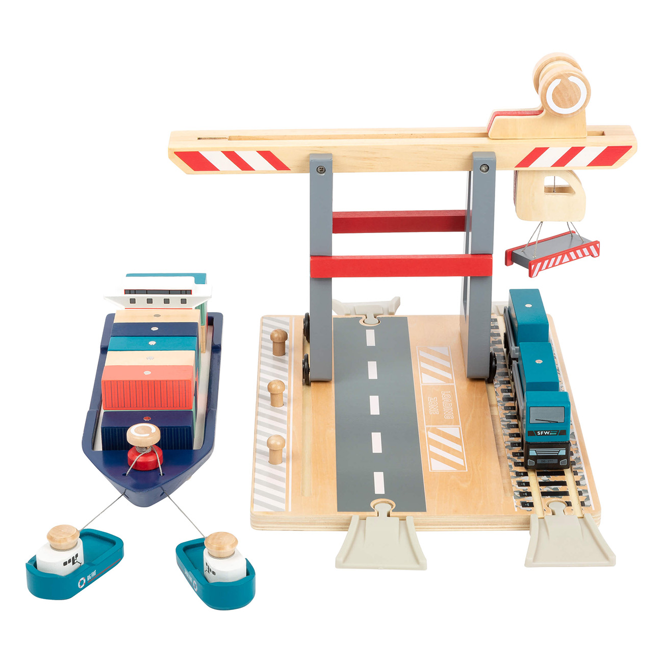 Ein hölzernes Spielzeug-Frachthafen mit Schiff, Zug und Schleppbooten. Es ist ein Kinderspielset.