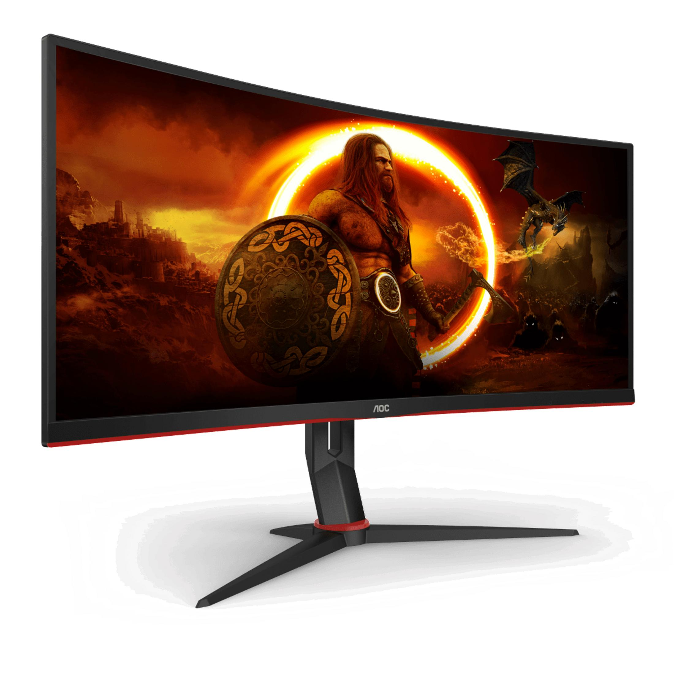 Ein gebogener Gaming-Monitor, der einen Krieger mit Schild und einen Drachen in einer feurigen Szene zeigt.