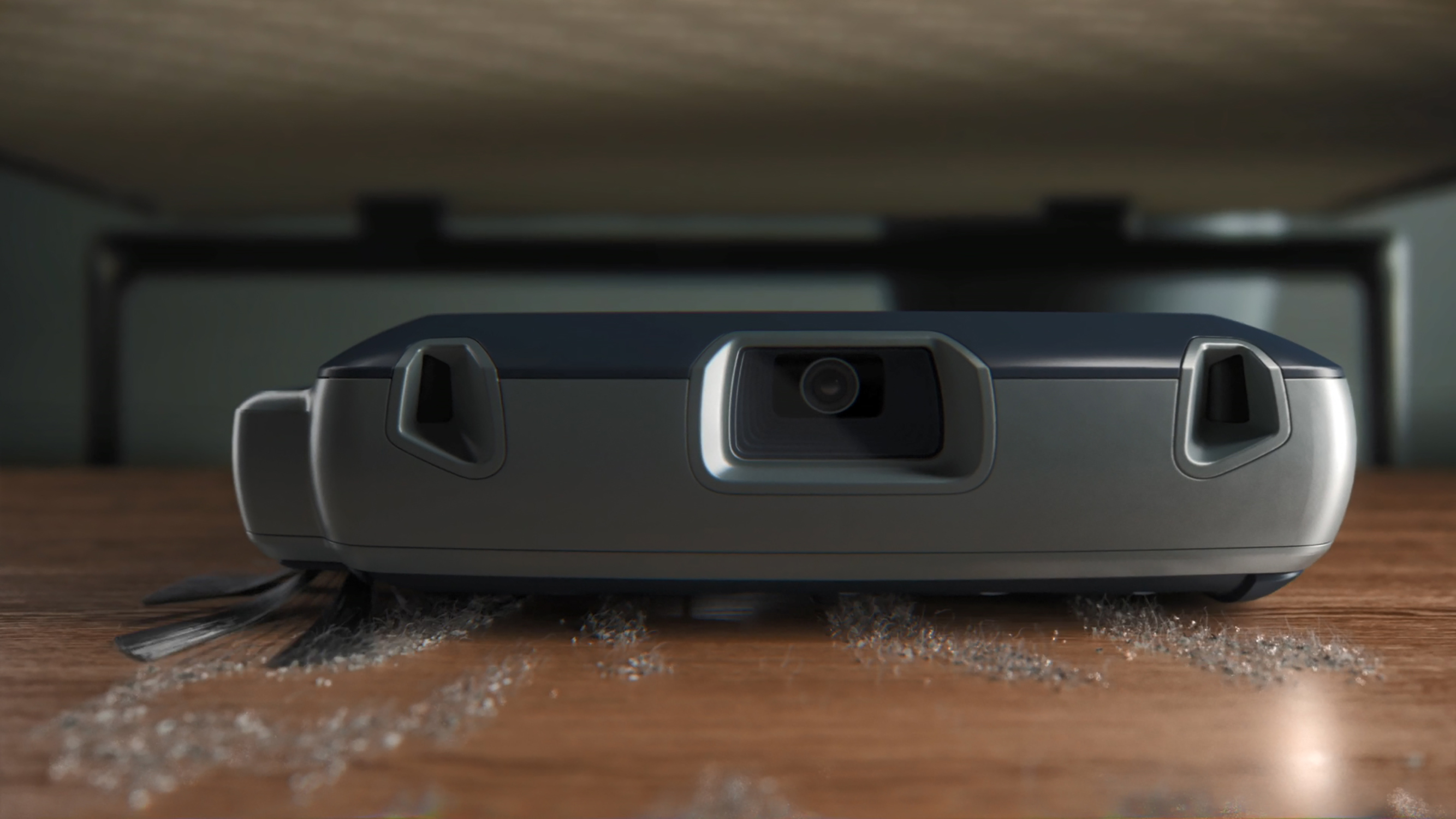 Robot sprzątający poruszający się po drewnianej podłodze, sprzątający pod łóżkiem.