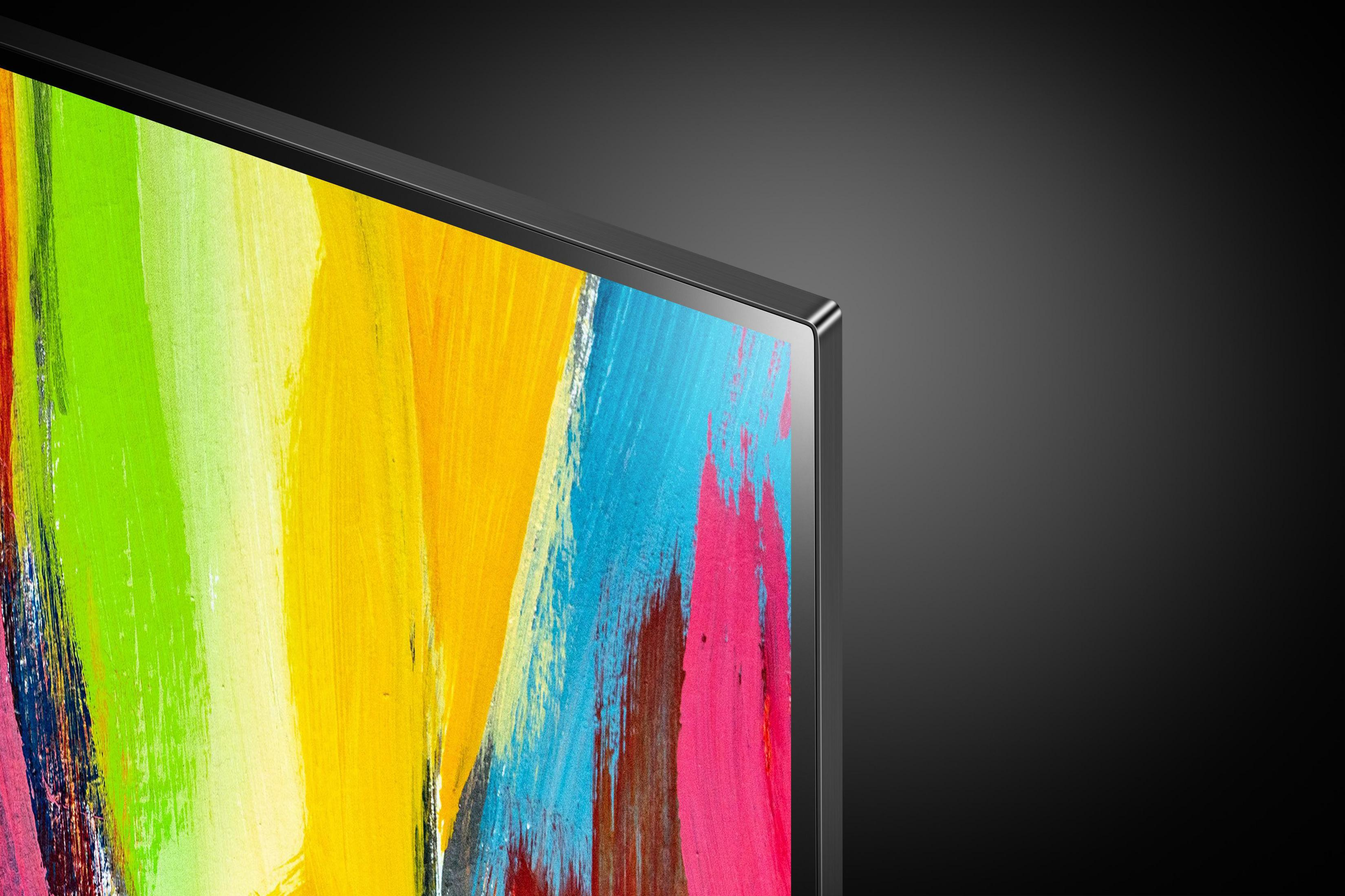 Primer plano de una pantalla de TV que muestra obras de arte coloridas. Marco negro, fondo oscuro.