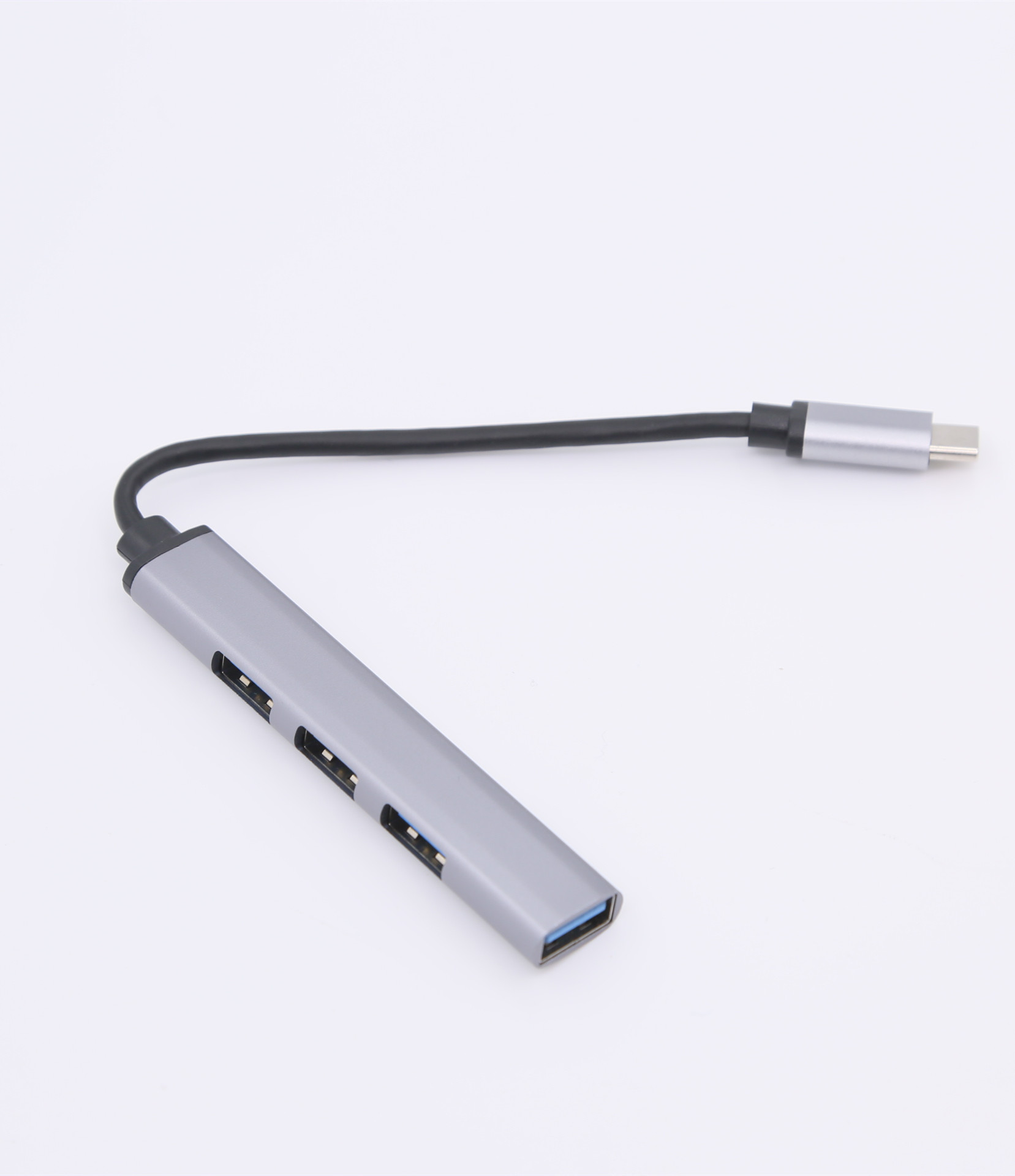Silberner USB-Hub mit 4 Anschlüssen und USB-C-Anschluss. Weißer Hintergrund.