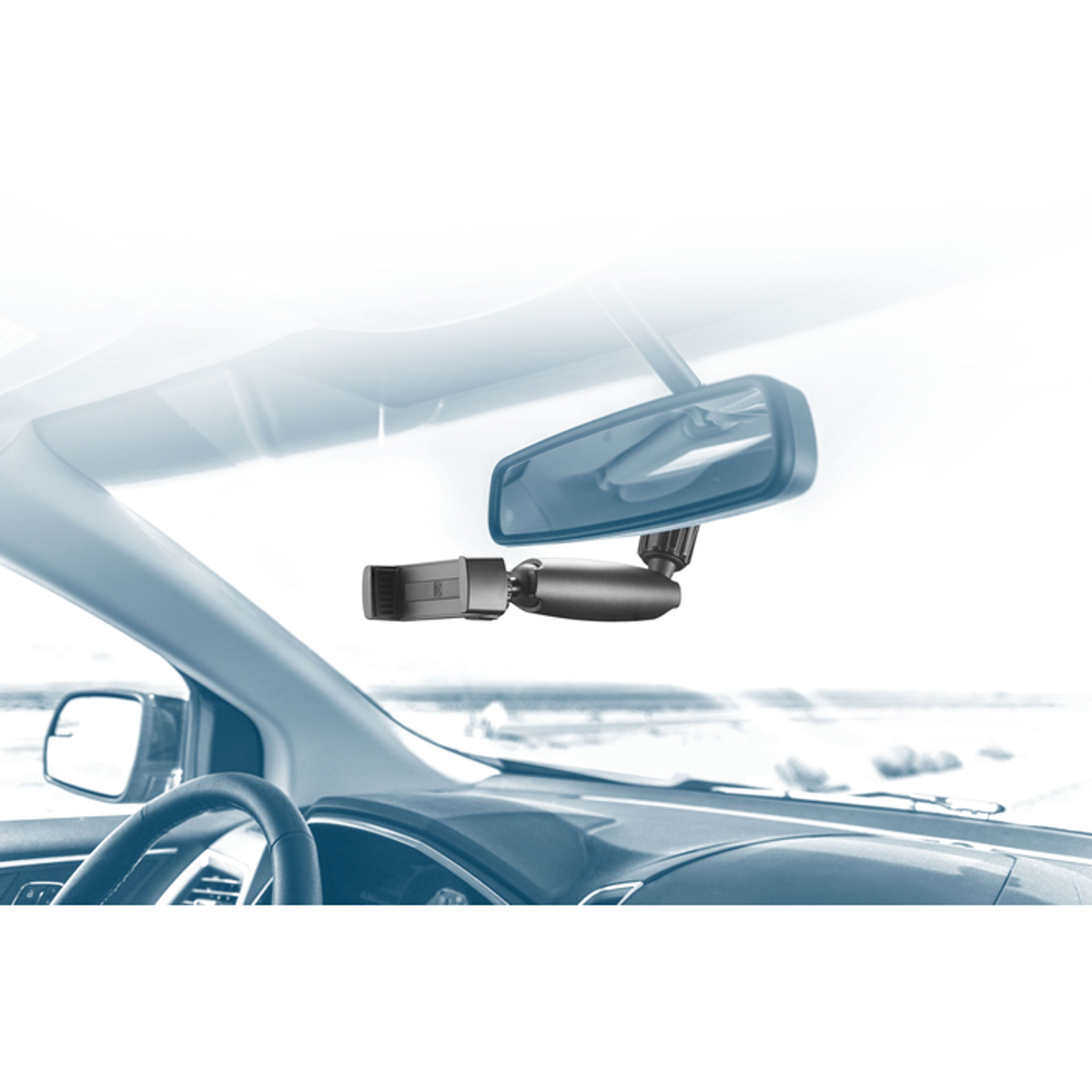 Un interior de coche con un soporte para teléfono adjunto al espejo retrovisor.