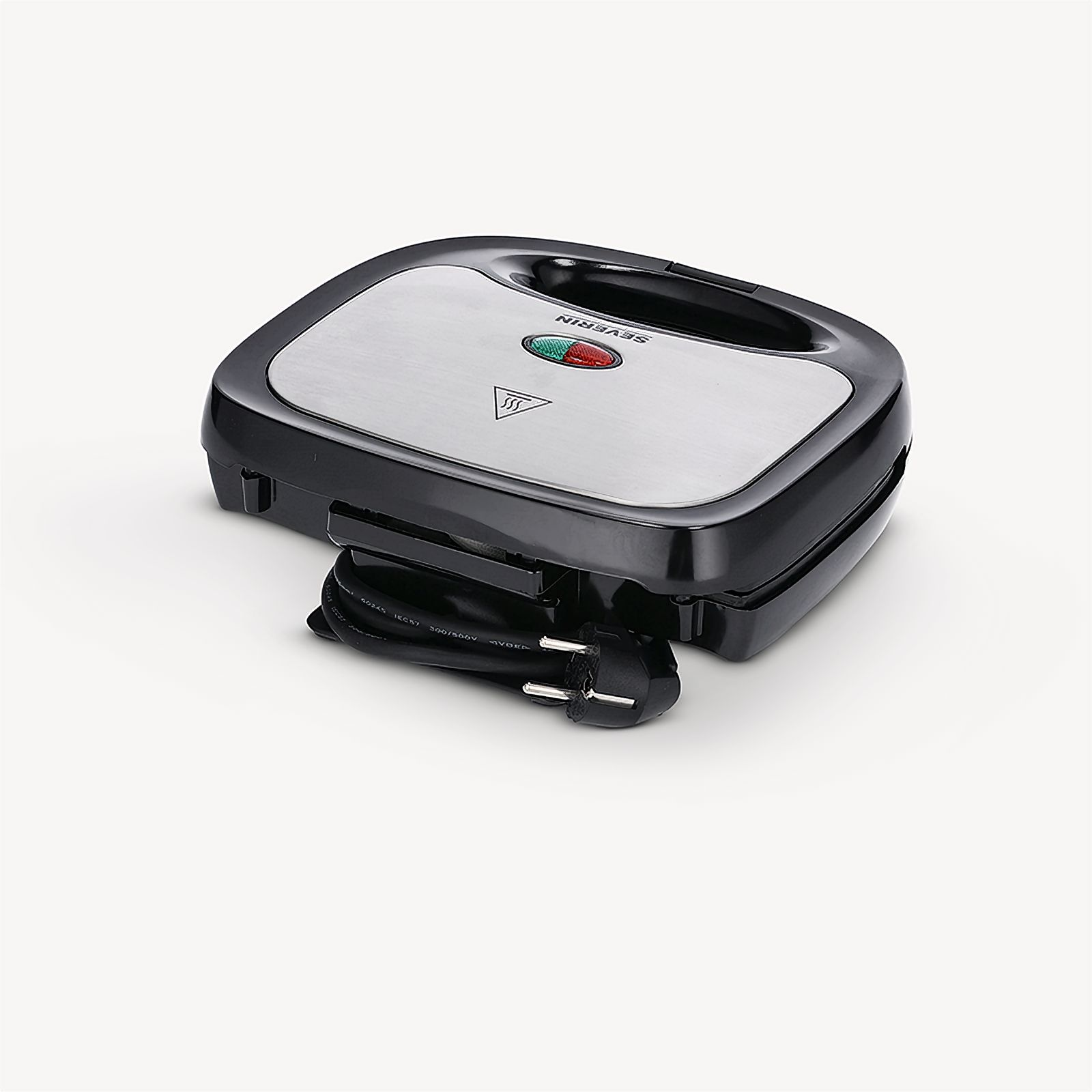 A black and silver sandwich maker with a closed lid and a power cord on a white surface.