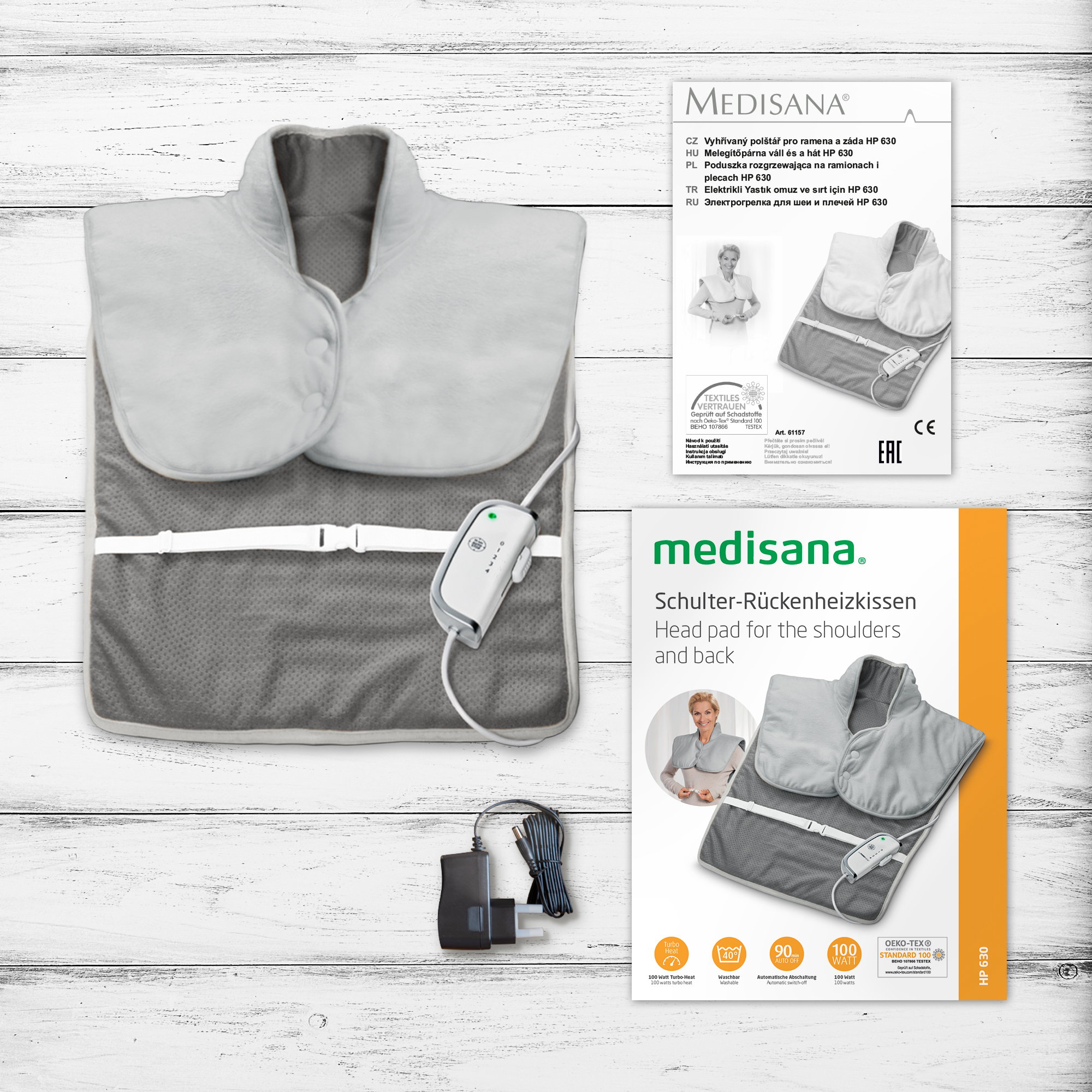 Poduszka grzewcza i instrukcje z zasilaczem i czarnym kablem ładującym.