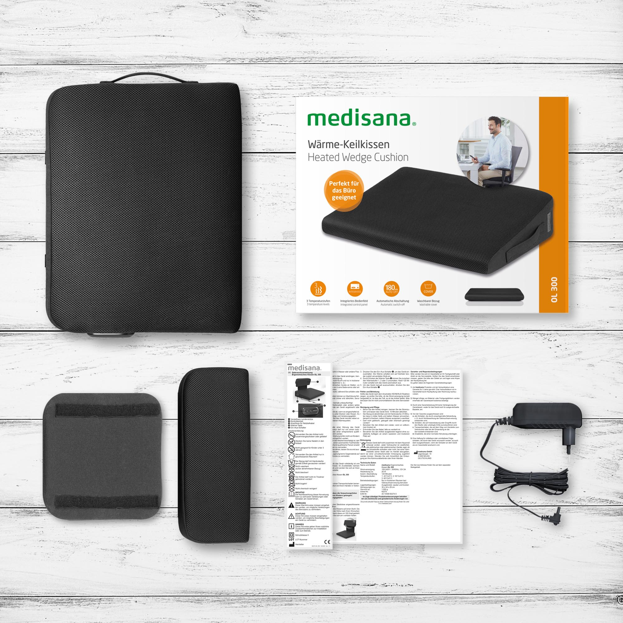 A black heated wedge cushion with packaging and accessories.
