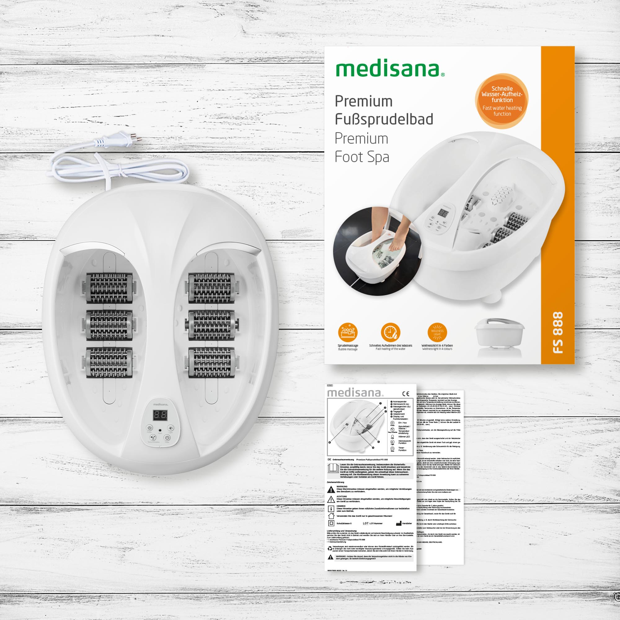White foot spa with accessories and box on a wooden surface, with the spa's top view.