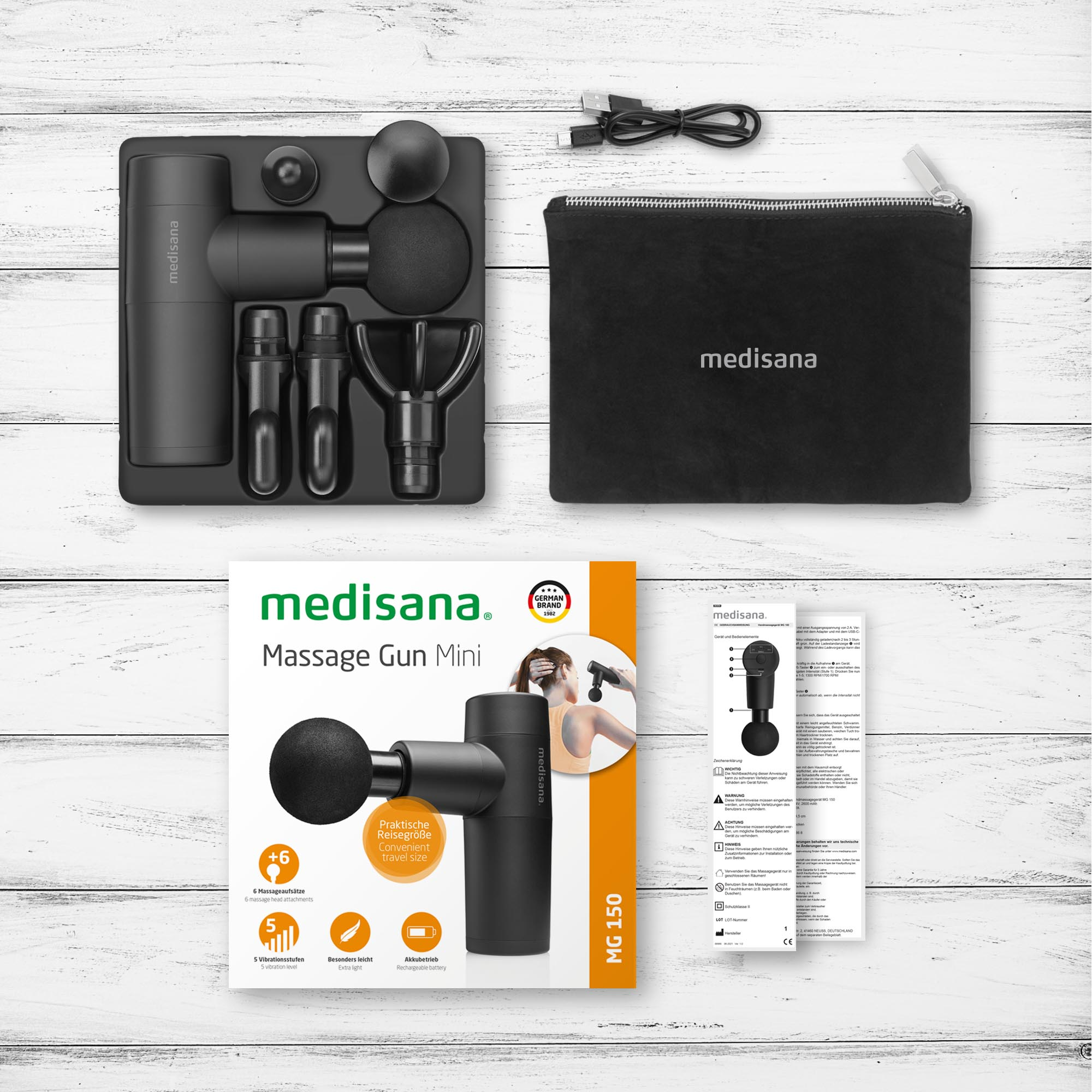 Ensemble Medisana Massage Gun Mini, avec accessoires et emballage, sur une surface en bois.