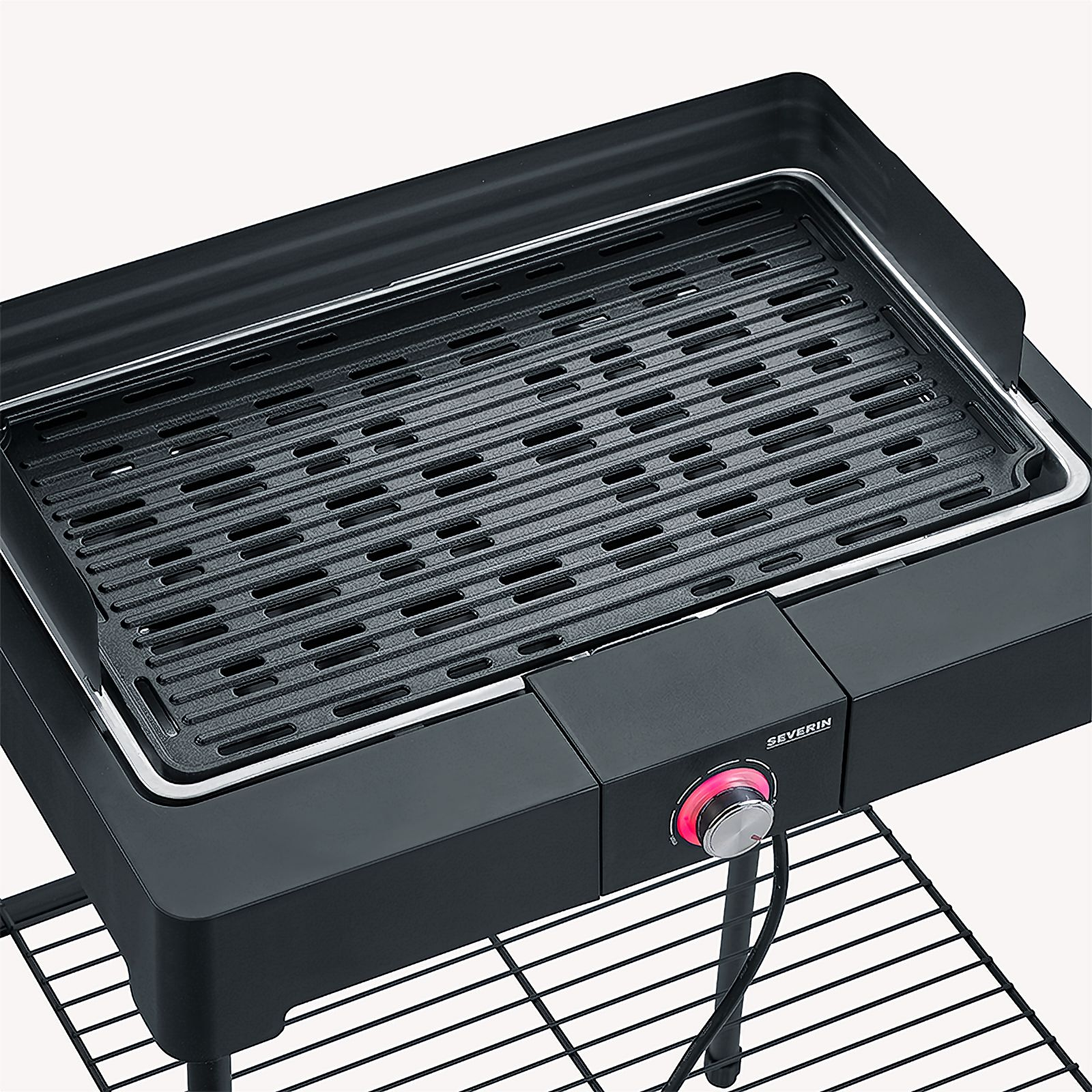 Black electric grill on a stand. Grill surface is visible. Red dial for temperature.