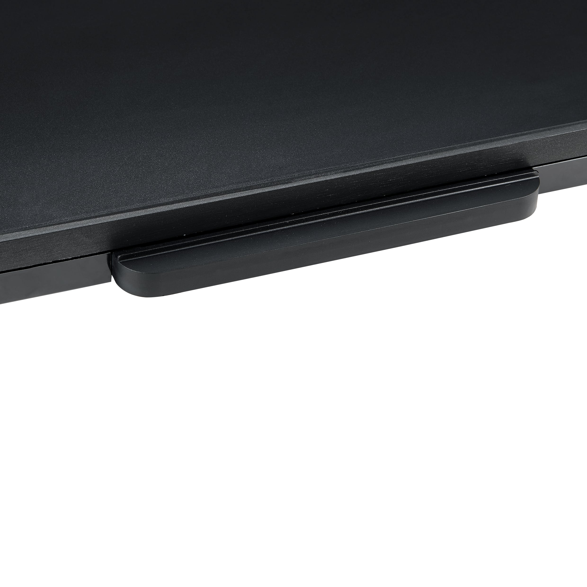 Close-up of a black handle on a black surface against a white background.