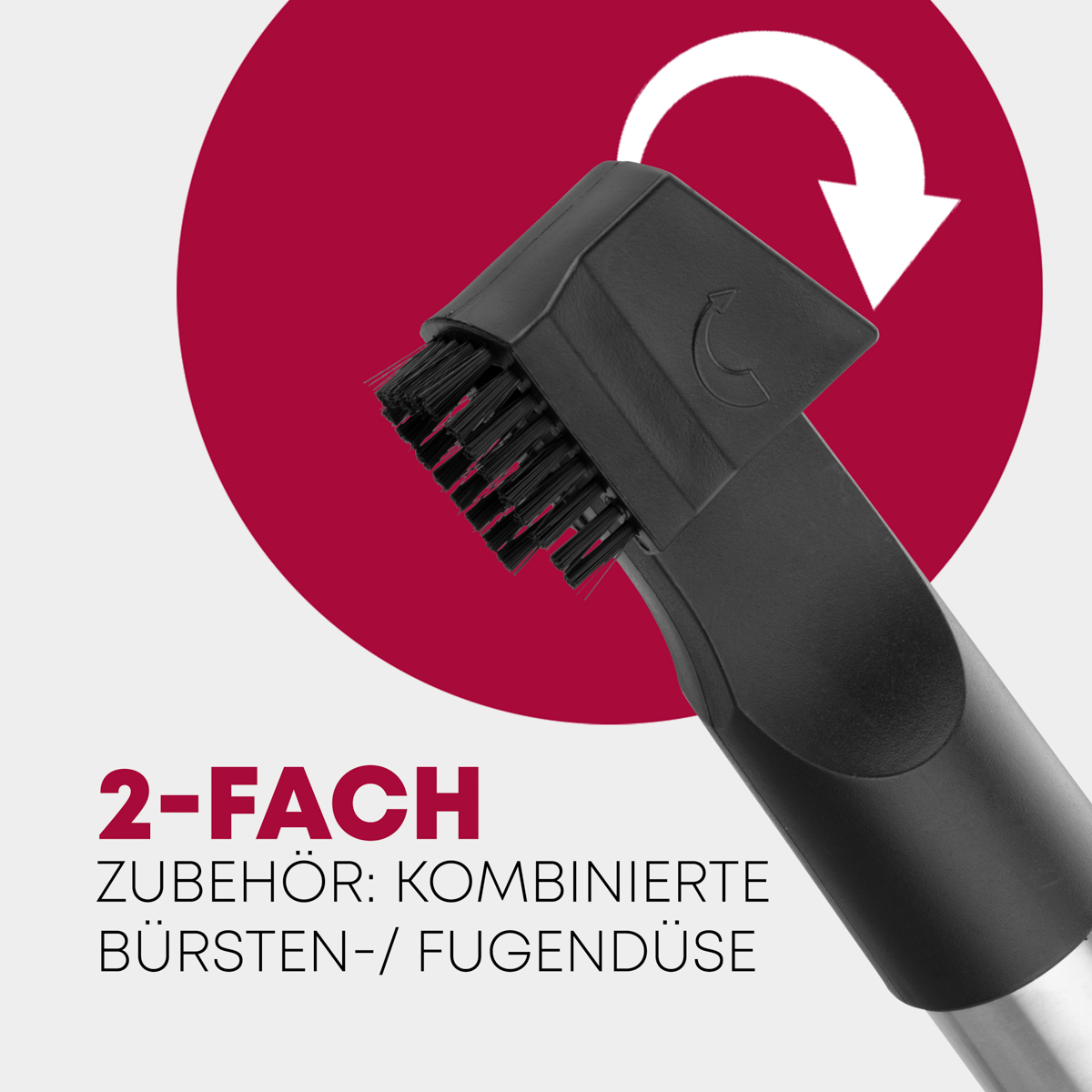 Czarna głowica odkurzacza ze szczotką. Czerwone koło z białą strzałką i tekstem.